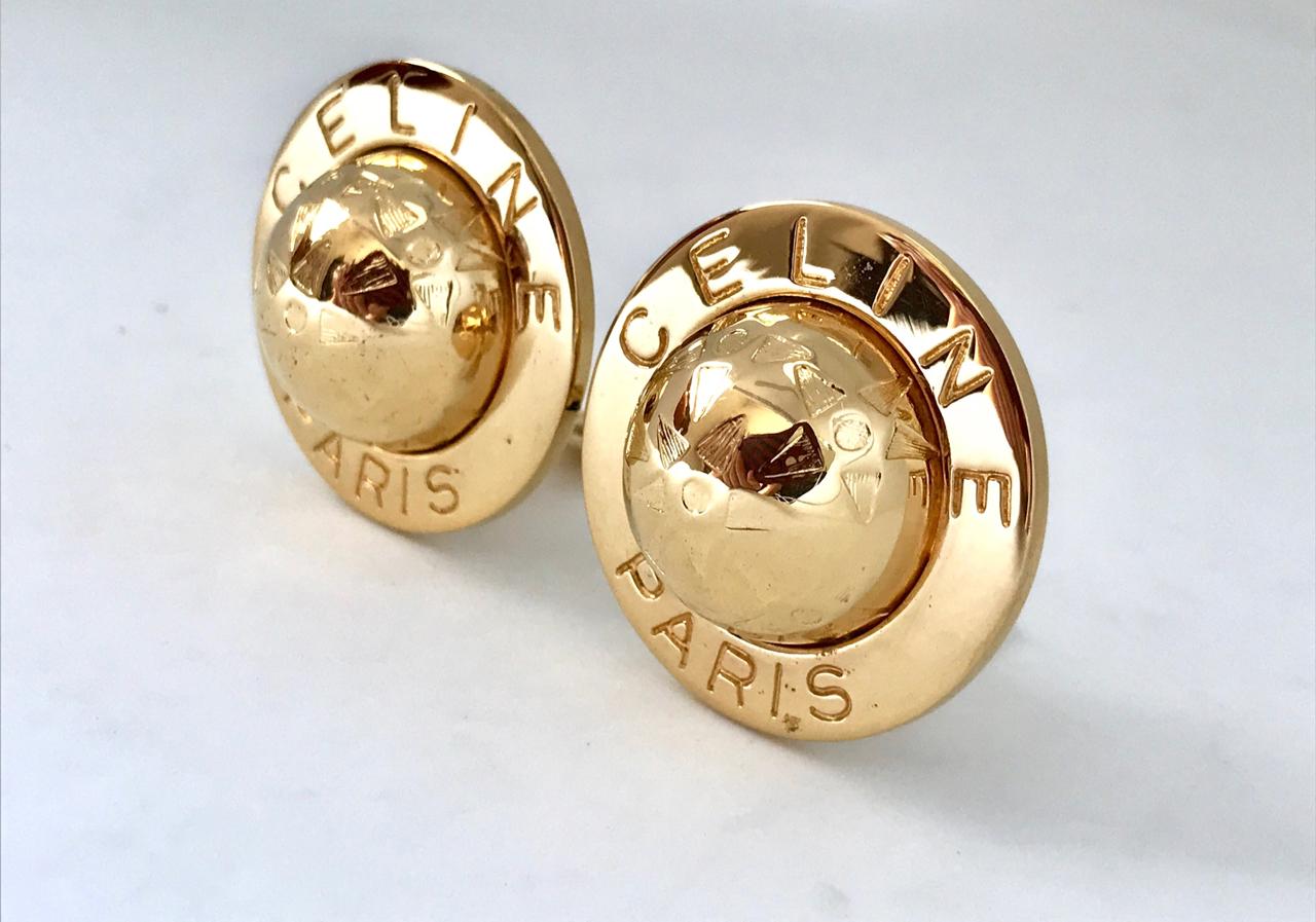 Celine 1990s (1992) Gold Plated Globe Clip on Oversized Statement Earrings.  

Featuring the iconic 90s Celine globe with the Celine name written around each earring.  Bang on trend, these are real showstoppers!   

Stamped 