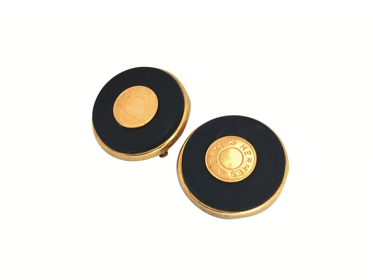 Hermes 24 Karat Gold Plated Black Leather Statement Clip on Earrings.

Hermes logo features around the centre of each earring.  Stamped 'Hermes Paris' on the reverse of each earring.

From the Sellier collection, these are highly collectable,