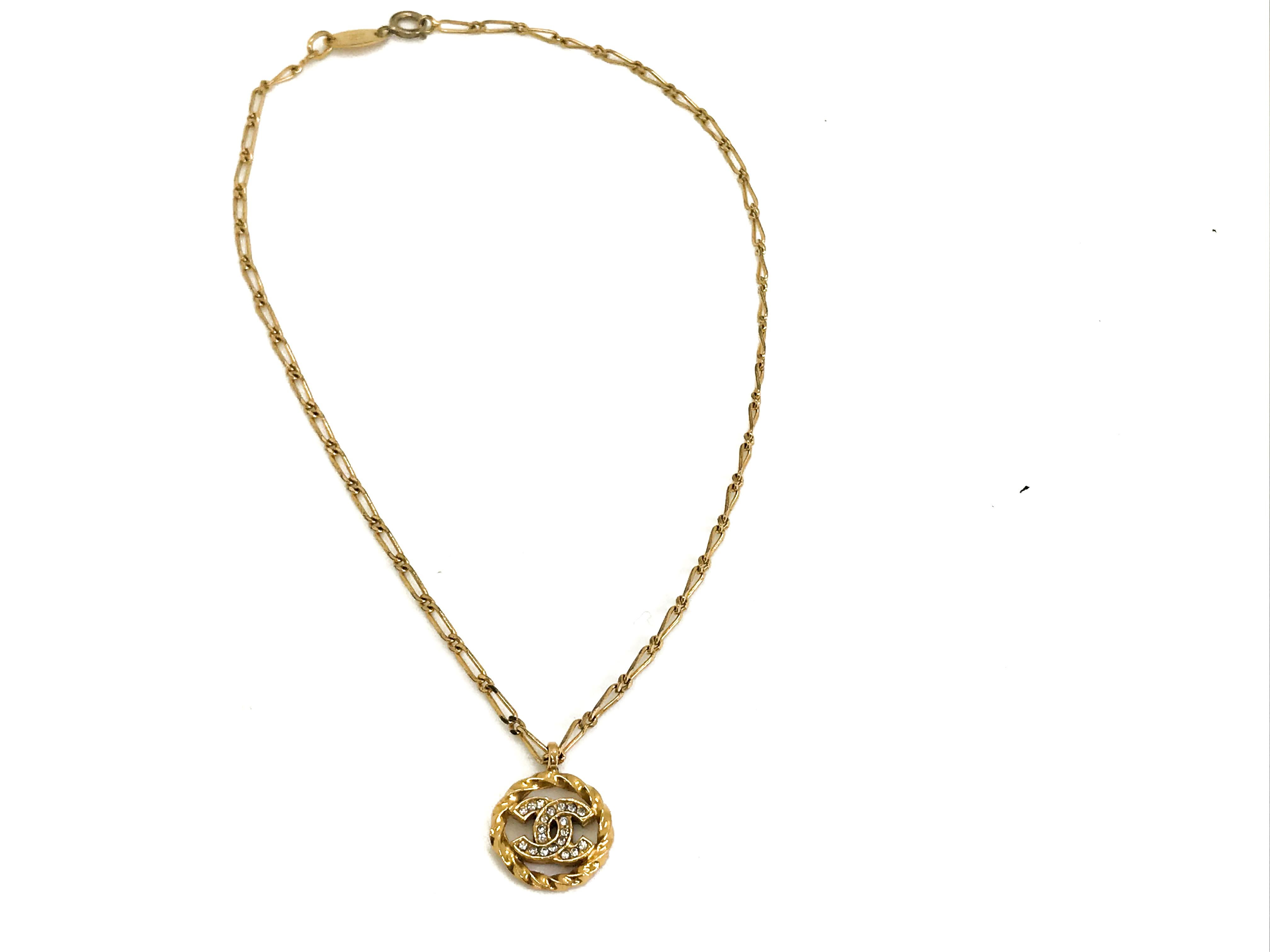Chanel 80s Vintage CC logo pendant necklace with delicate chain.  Made in 1982.  Features the classic Chanel Made in France 1982 hangtag which is attached to the chain.

A delicate, versatile piece which will see you from desk to dance floor.

Chain