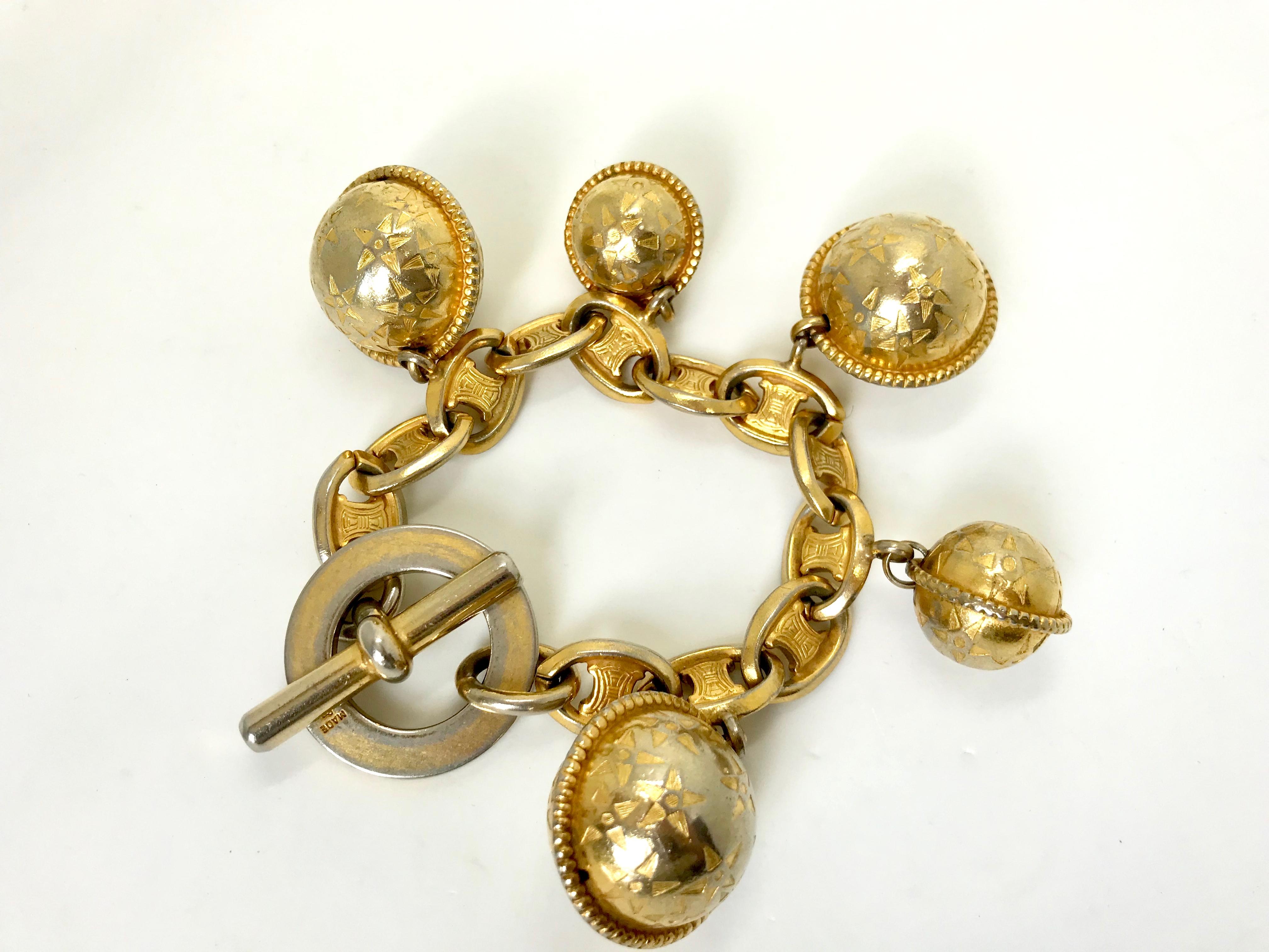 Celine 1980s Vintage Globe Charm Bracelet

Celine 1980s Vintage Globe Bracelet.  The chain is made of the Celine Macadam logos and is made of gold tone metal. 4 large and small iconic Celine globe charms hang from the chain.

A real statement show