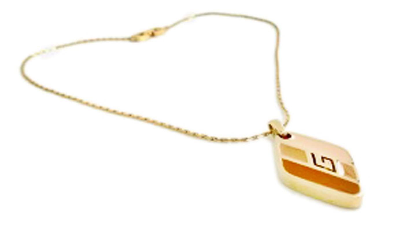 Givenchy 1970s Vintage Tan Enamel Pendant on chain (1979).

Diamond shaped pendant enamelled in three beautiful tan shades.

A subtle statement piece from the Givenchy vintage heyday (1977-1981) where quality was impeccable and designs straight from