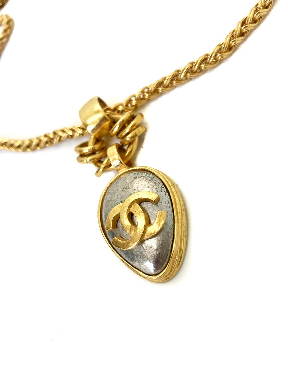 Chanel 1990s (1997 A) Gold Plated Pendant Necklace on chunky gold plated chain.  The iconic CC logo is emblazoned in gold plate on the silver coloured pendant. 

Designed for the 1997 Autumn Winter Collection, this piece is so evocative of Chanel's