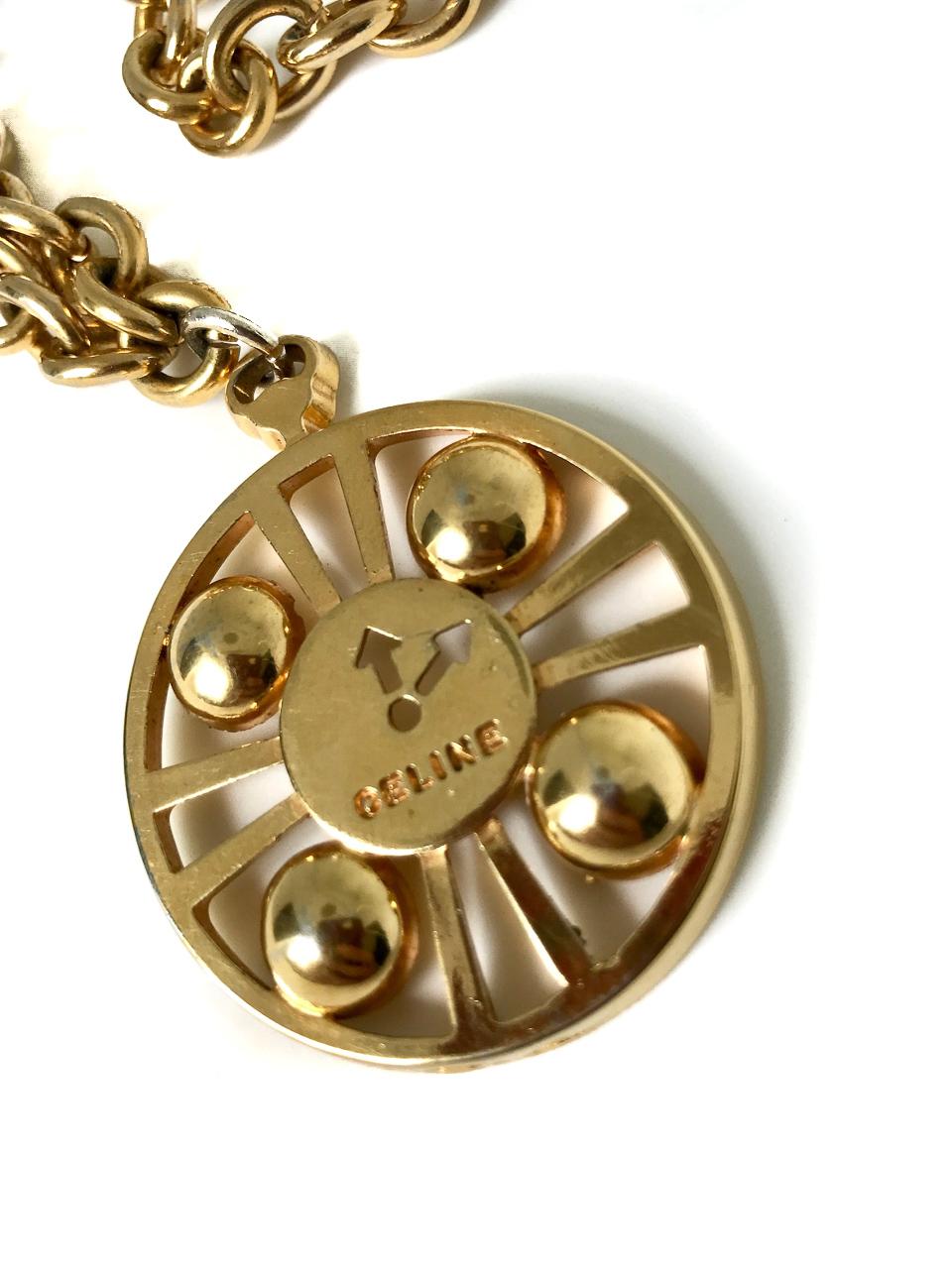 Celine 1990s Vintage Gold Plated Clock Pendant Necklace.  Can also be worn as a belt.

Rare, super cool and unexpectedly versatile.  Think 90s supermodels or late 80s / early 90s hip hop.  

Stamped 
