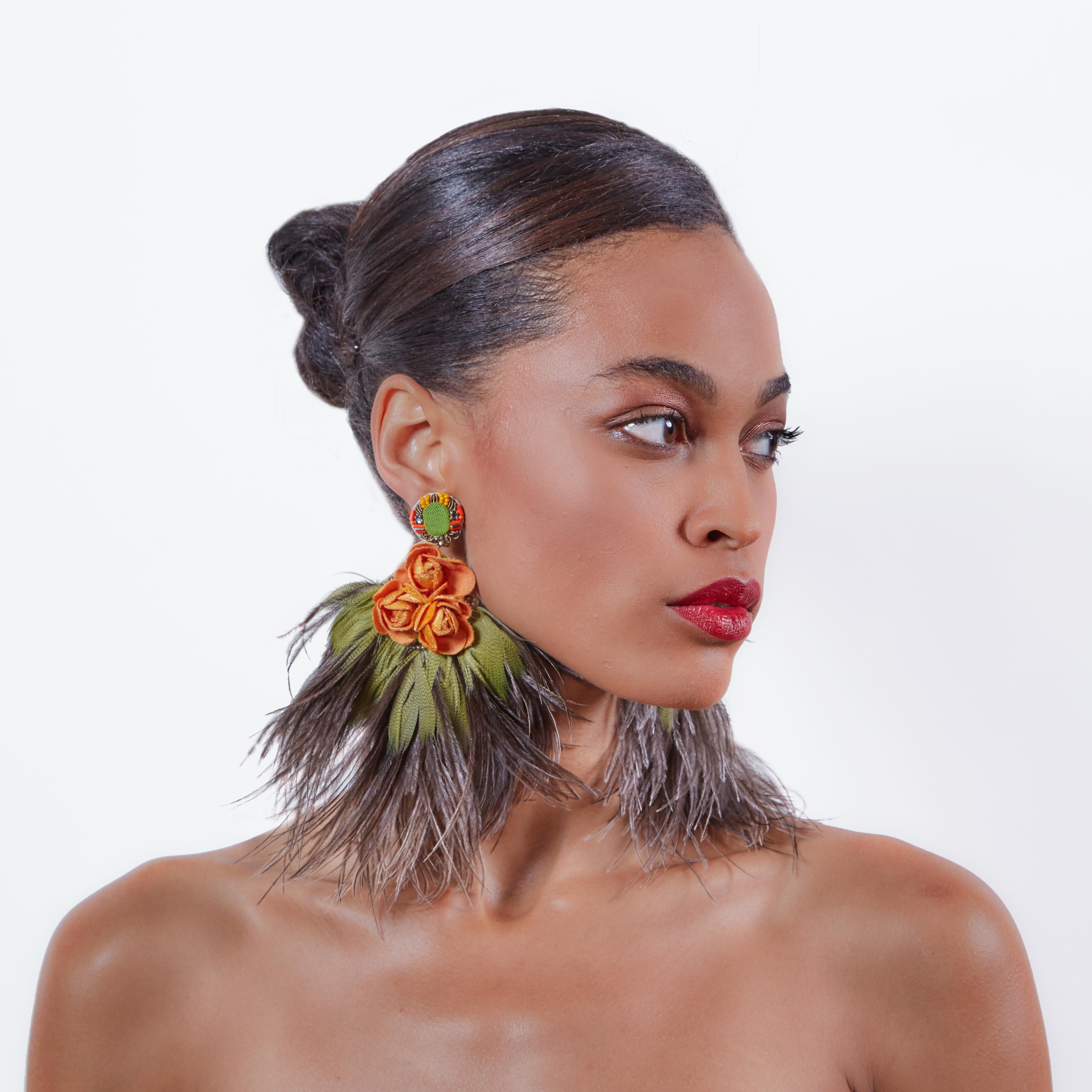 Make a bold statement in the Cattleya earring. Large ostrich feathers and warm colors make a perfect statement for Fall. 