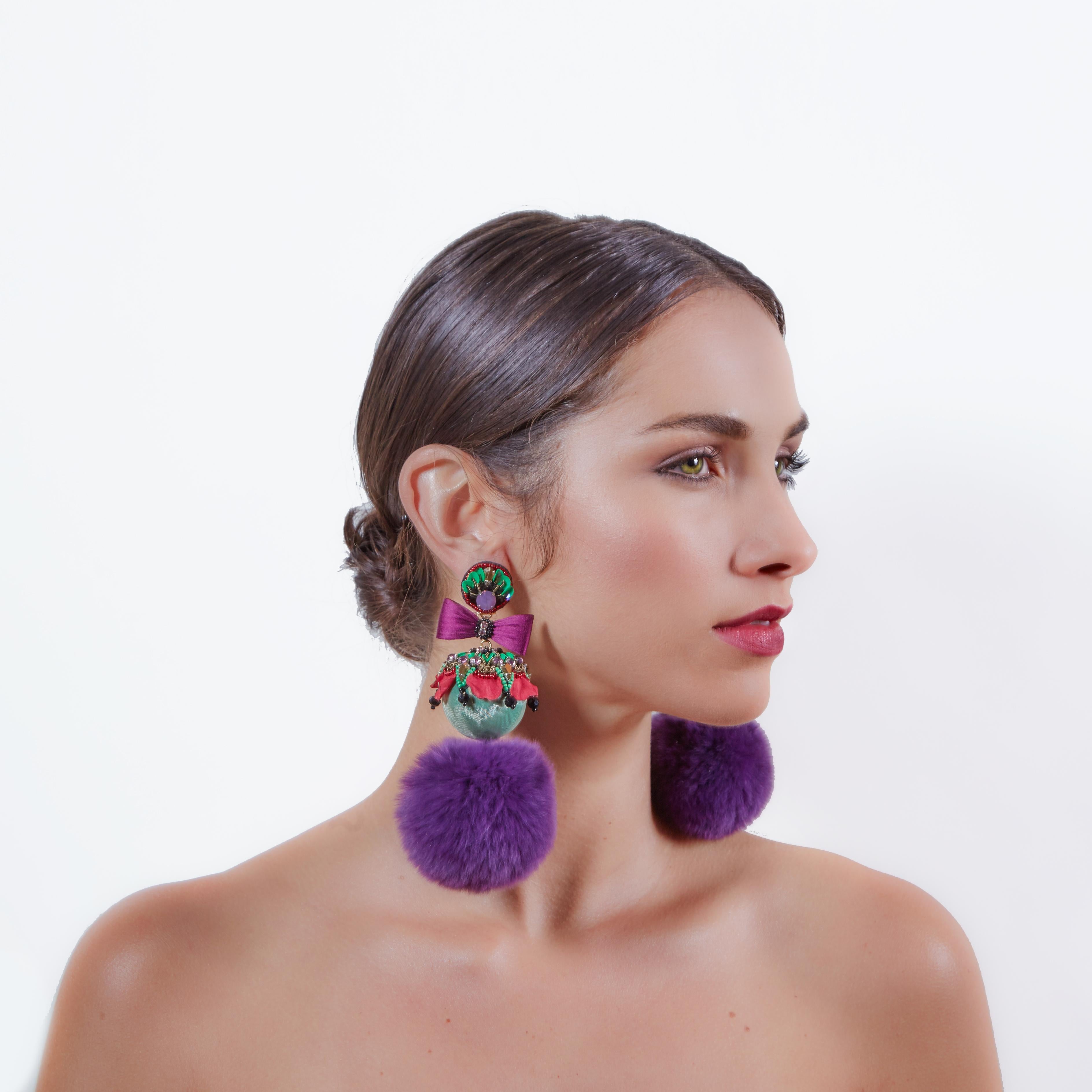 Create a feeling of luxurious sophistication with the Itatiai earring. Mink fur poms, crystals, and silk bows make Itatiai and extravagant piece for your Fall wardrobe.