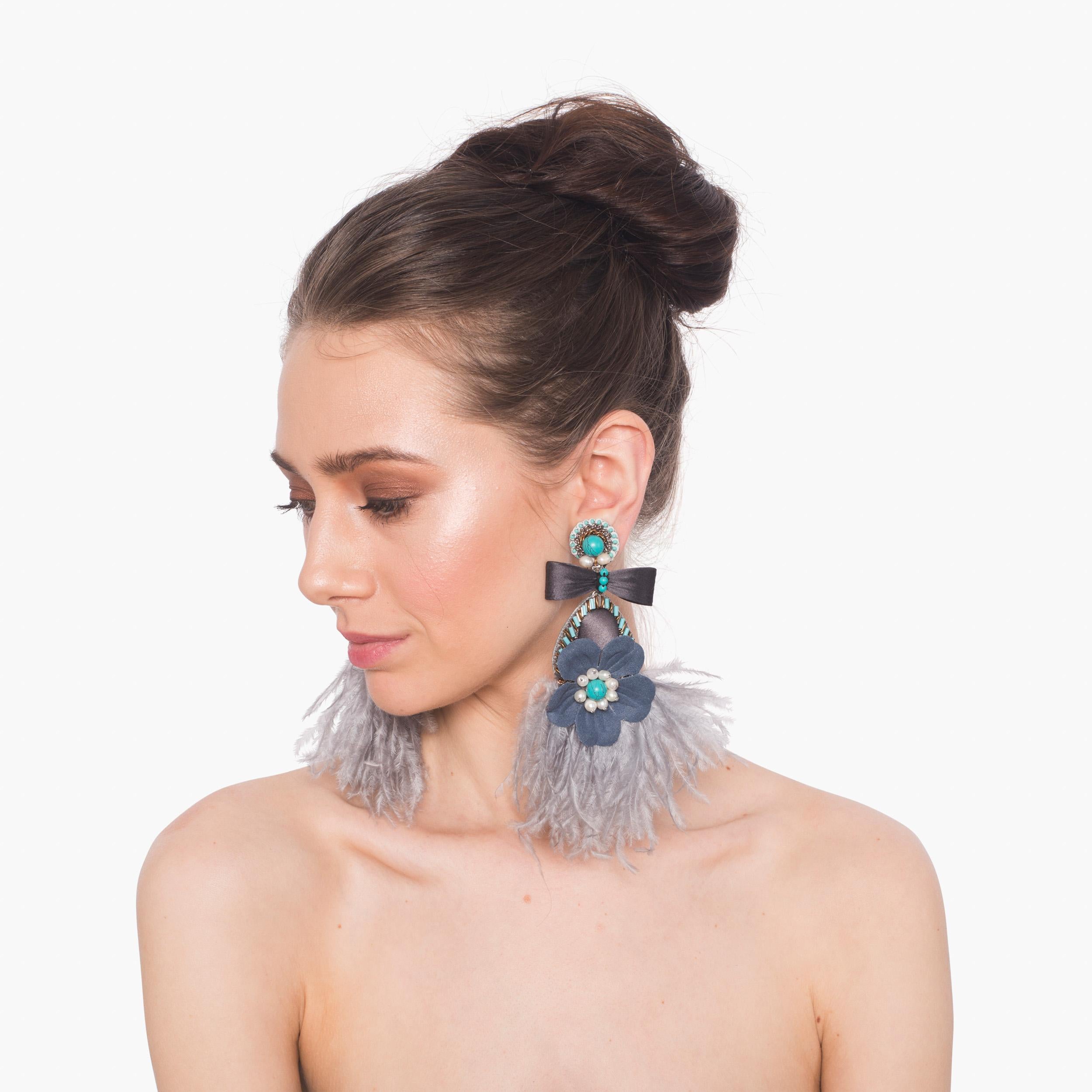 Femininity abounds in the Lago earring. Mother-of-pearl, fabric florals, and delicate ostrich feathers make Lago the perfect statement earring.