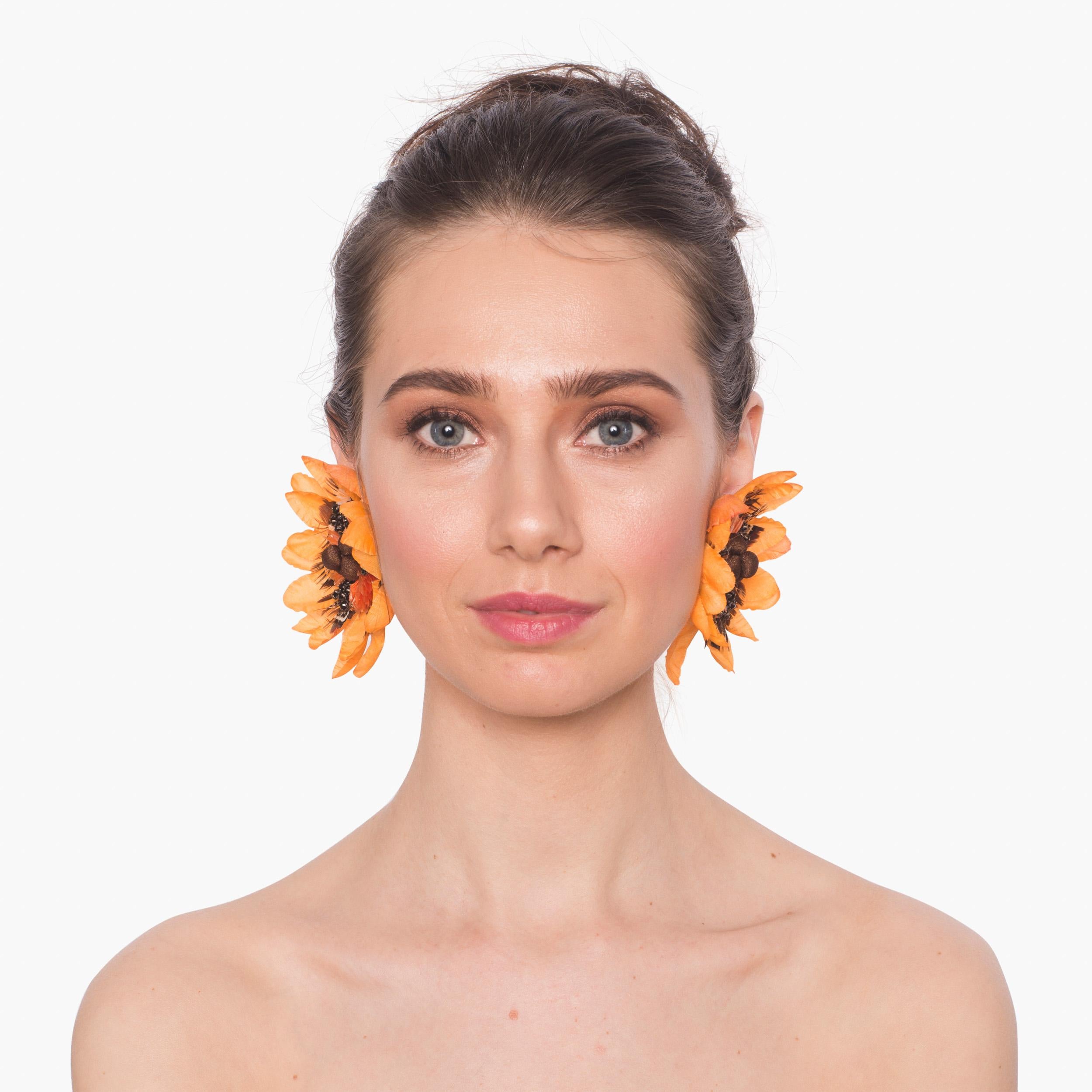 Add an element of liveliness to your look with the Begonia earring. Bright orange silk petals, pheasant feathers, and crystals make Begonia a pop of color for any wardrobe.