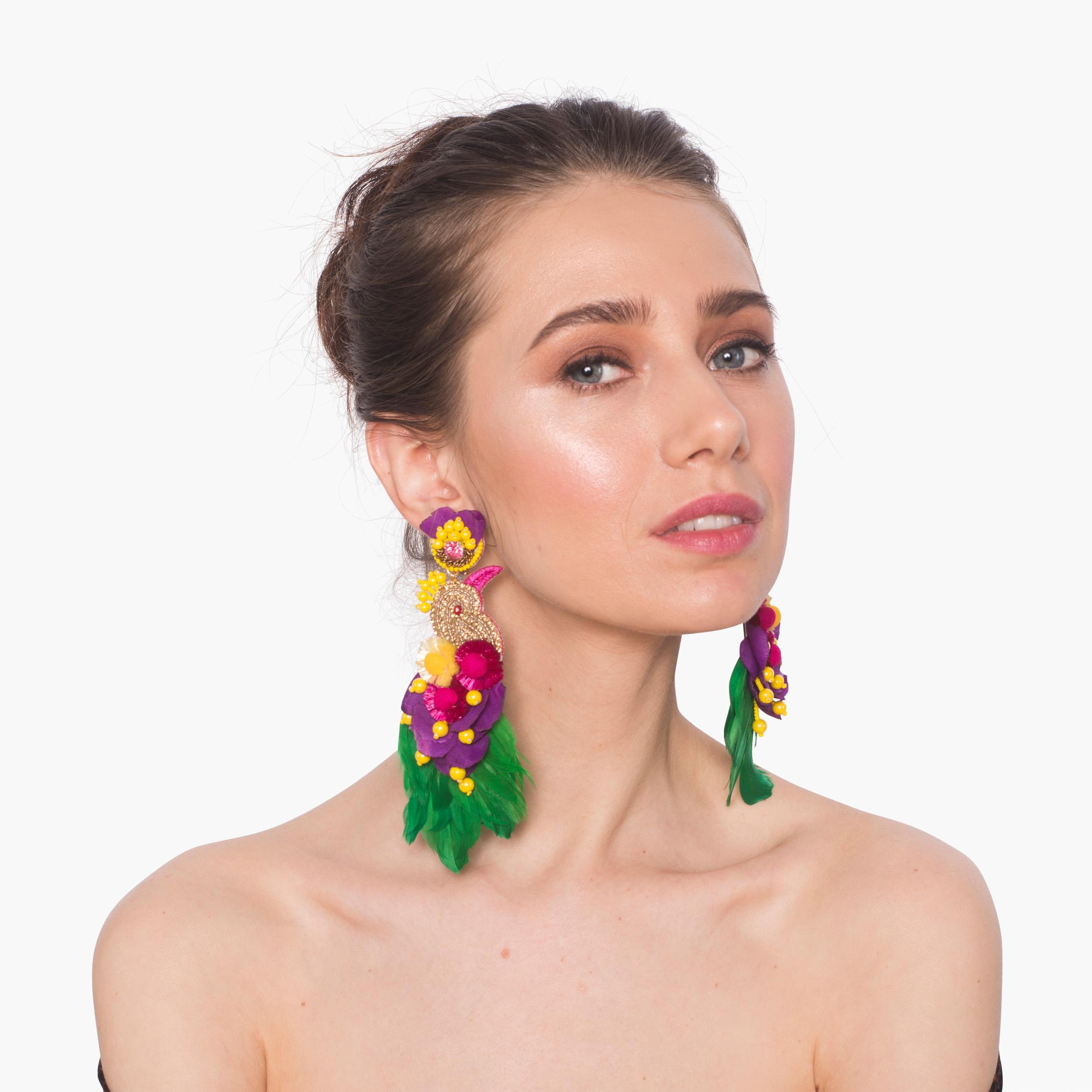 Travel to paradise in the Toucanet earring. Crystals, Raffia, and coque feathers make Toucanet a festive statement piece for any wardrobe.