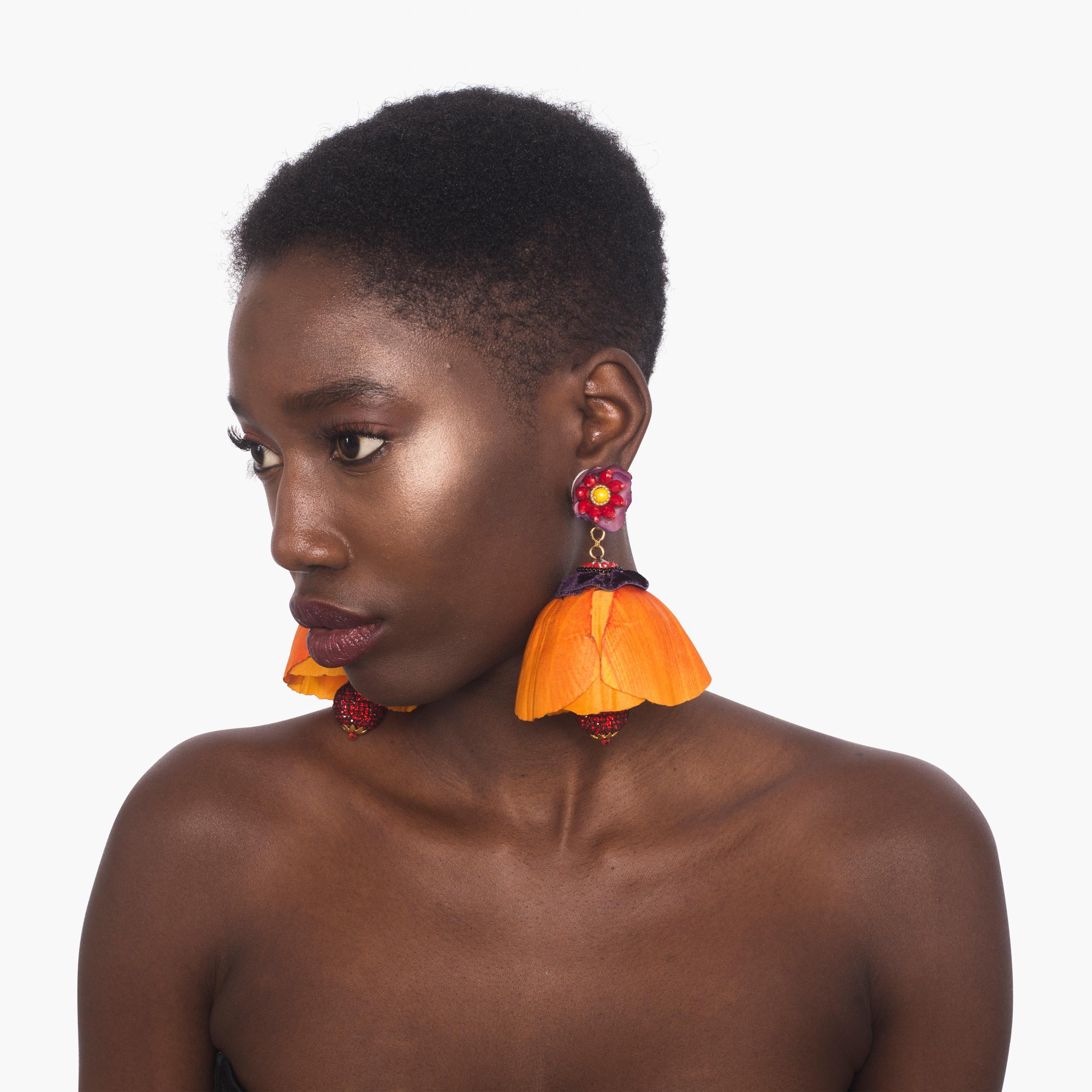 Make a flirtatious statement in the Tecoma earring. Silk Petals and crystals cascade down the earring, making it a fun flirtatious piece for any wardrobe. 