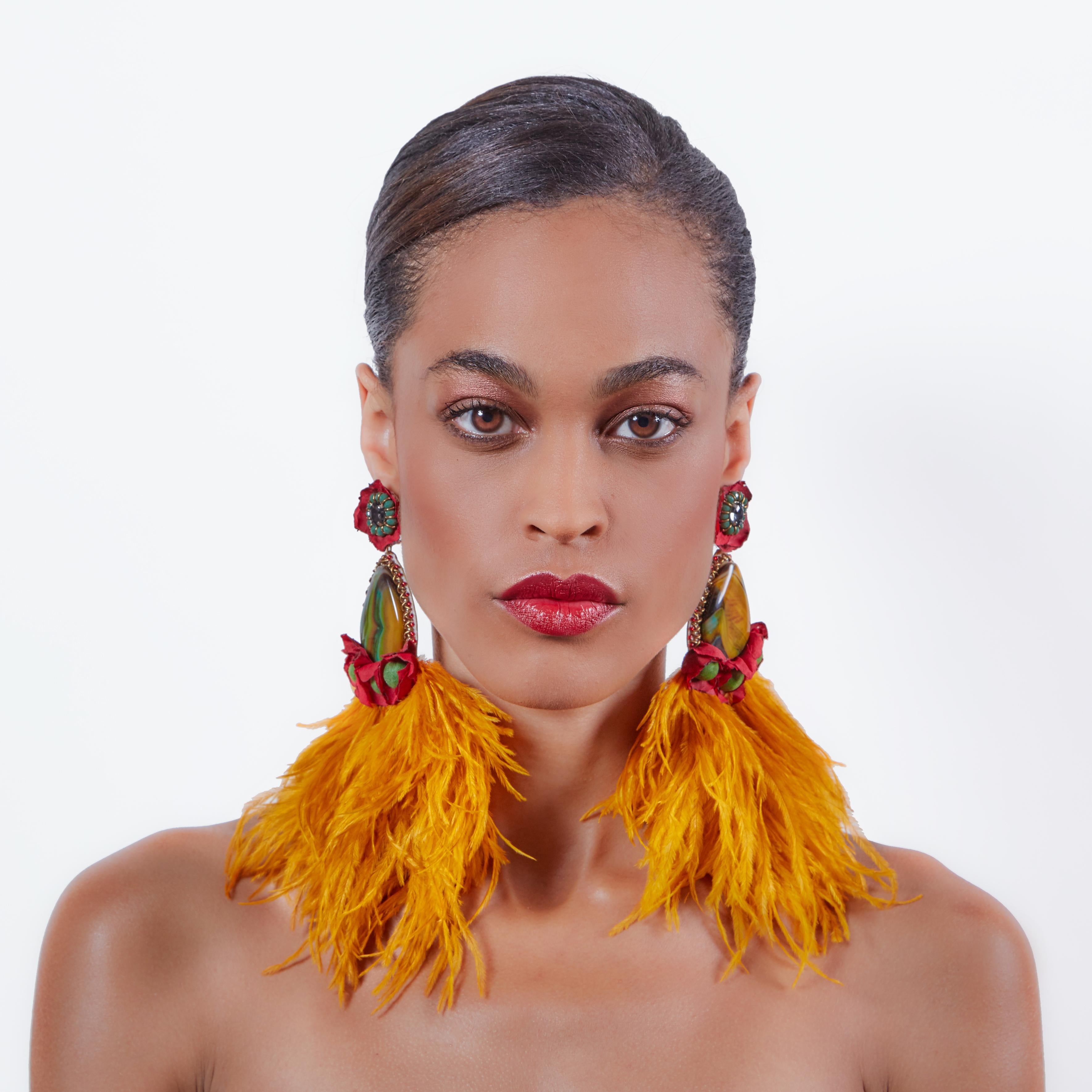 Make a bold statement in the Santana earring. Large agate stones and extravagant ostrich feathers ensure that Santana will turn heads.