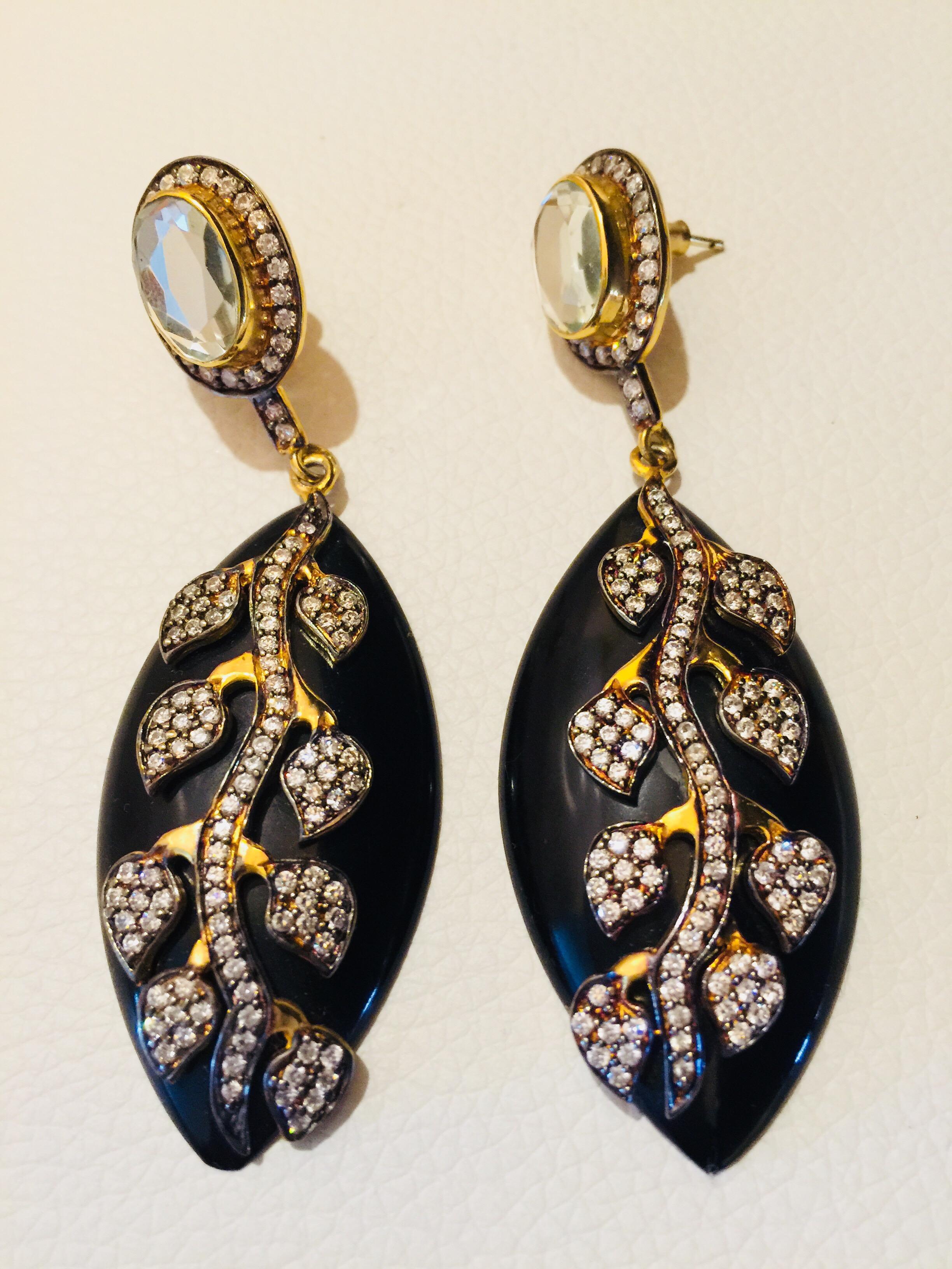 The gorgeous look of these gold, black and CZ leaf earrings is equaled only by the artisan craftsmanship and quality materials used to create them. Jet black ovals are enhanced with a crystal and gold 
