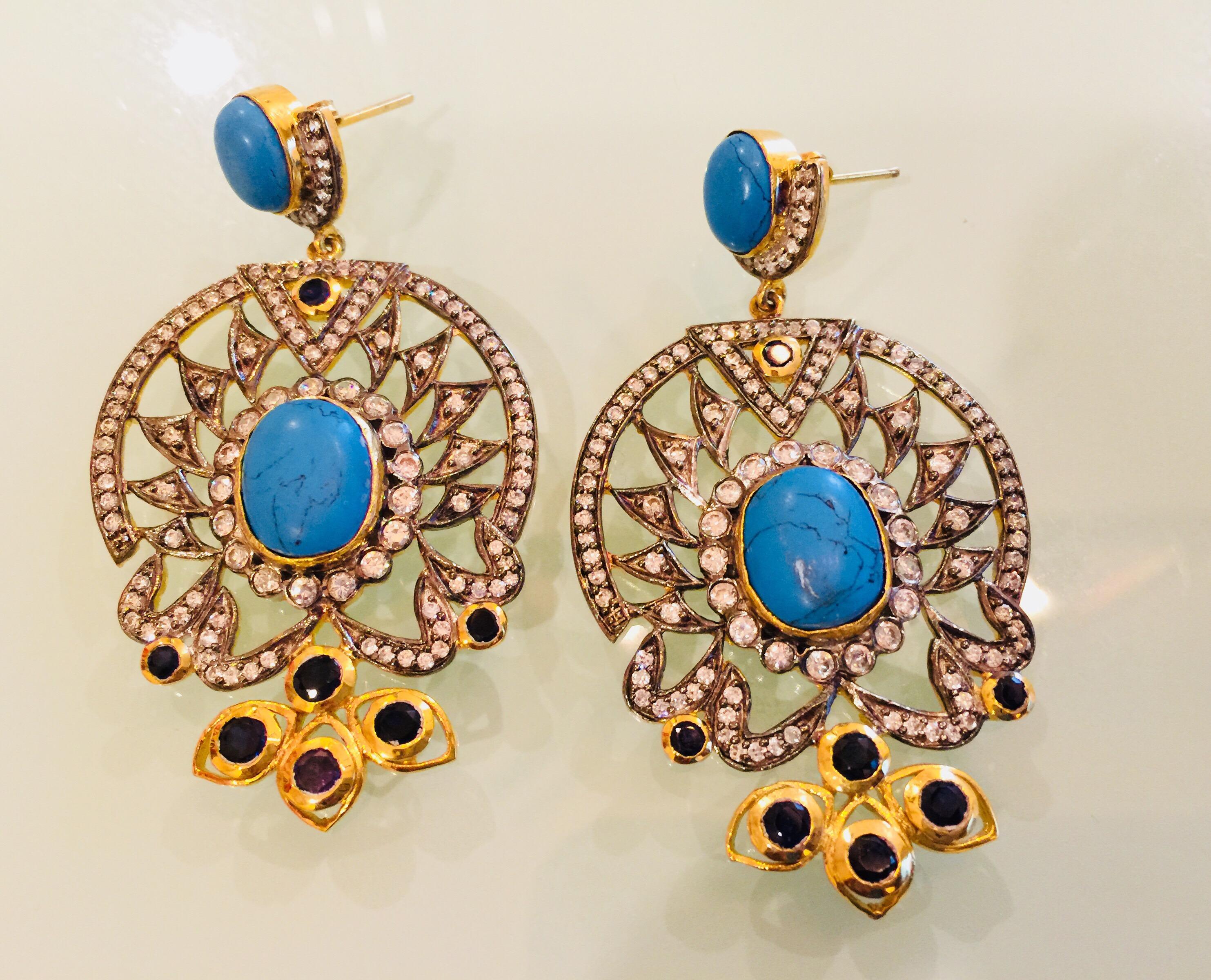 The design is ornate and lovely, the striking turquoise stone is enhanced by quartz stones and sparkling CZ stones. Earrings have a post closure for pierced ears.

A short video can be requested for this piece.
Stone: Turquoise, quartz, cubic