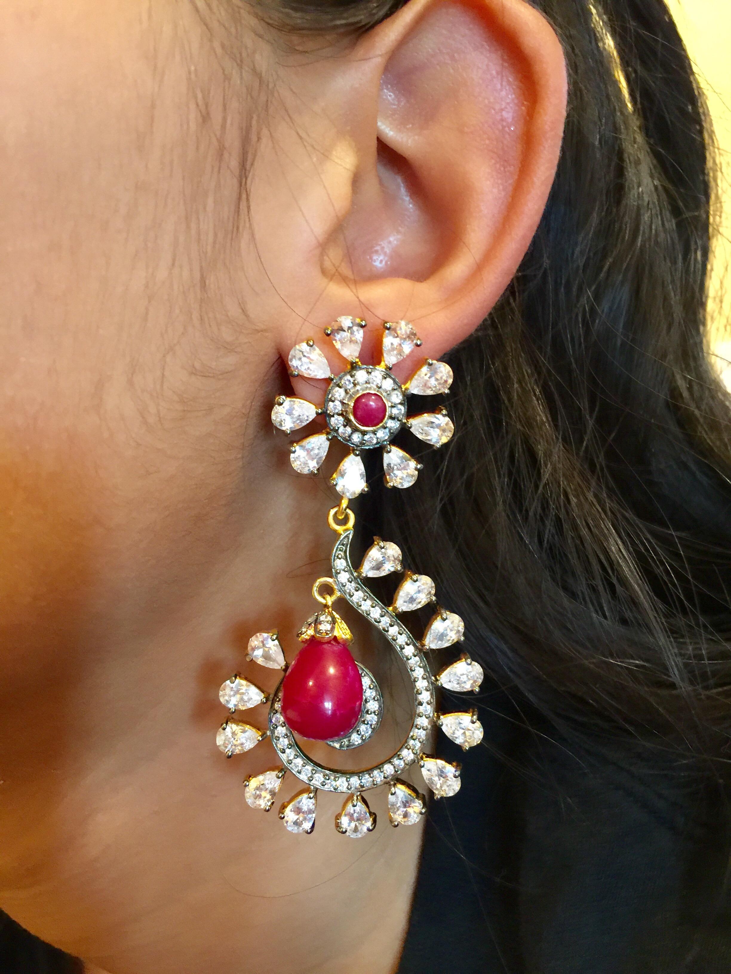 The Taj Mahal inspired design is ornate and lovely, the earrings is further enhanced by quartz stones and sparkling CZ stones overall. Earrings have a post closure for pierced ears.

Stone: Quartz, cubic zirconia

Length: 2.8 inches

Width: 1 1/2