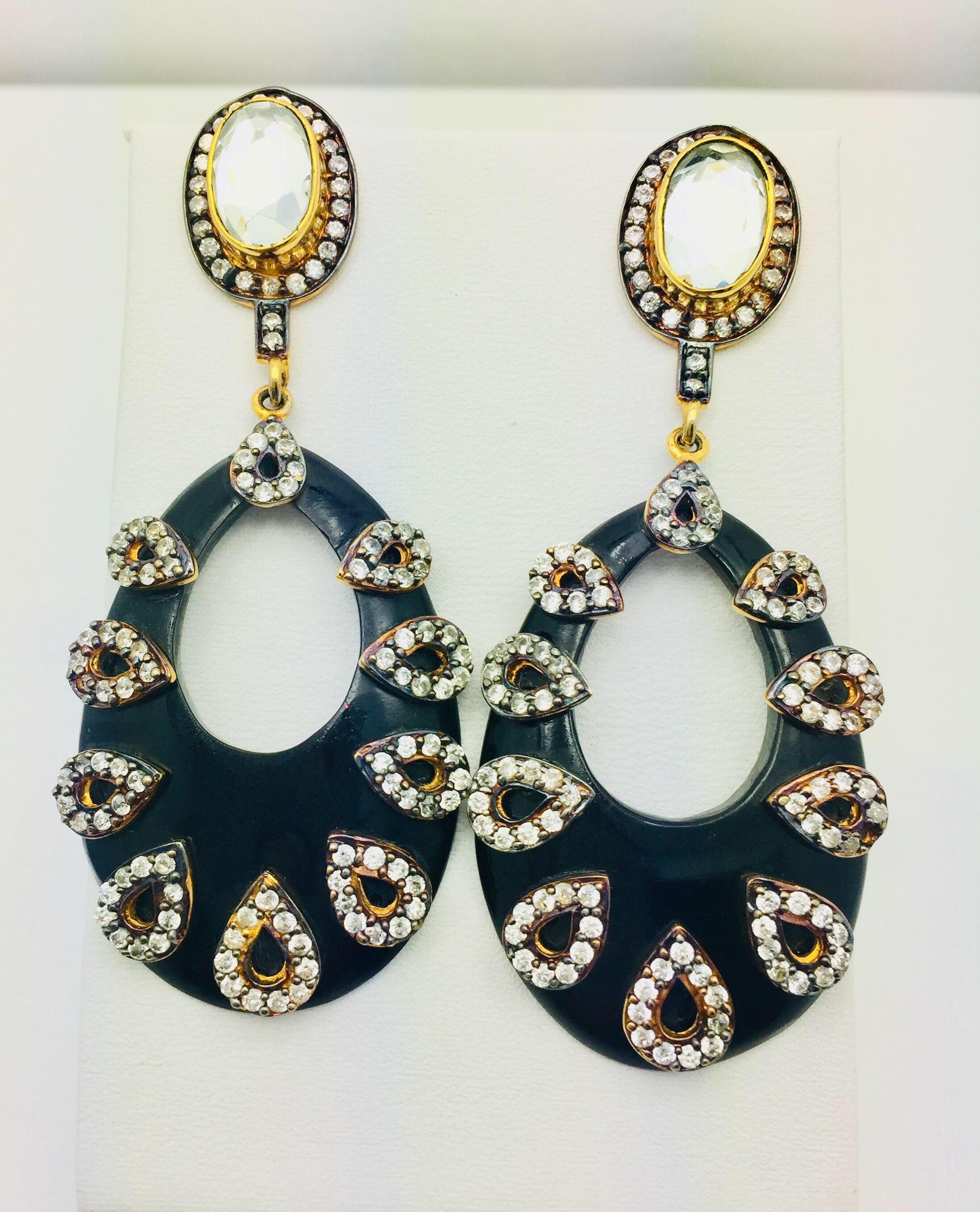 A black teardrop hoop shape is beautifully enhanced with teardrops made from small CZ stones, and suspended from a large, oval, faceted stone at the top. These earrings accessorize dozens of wardrobe choices: dressing up a casual look or adding a