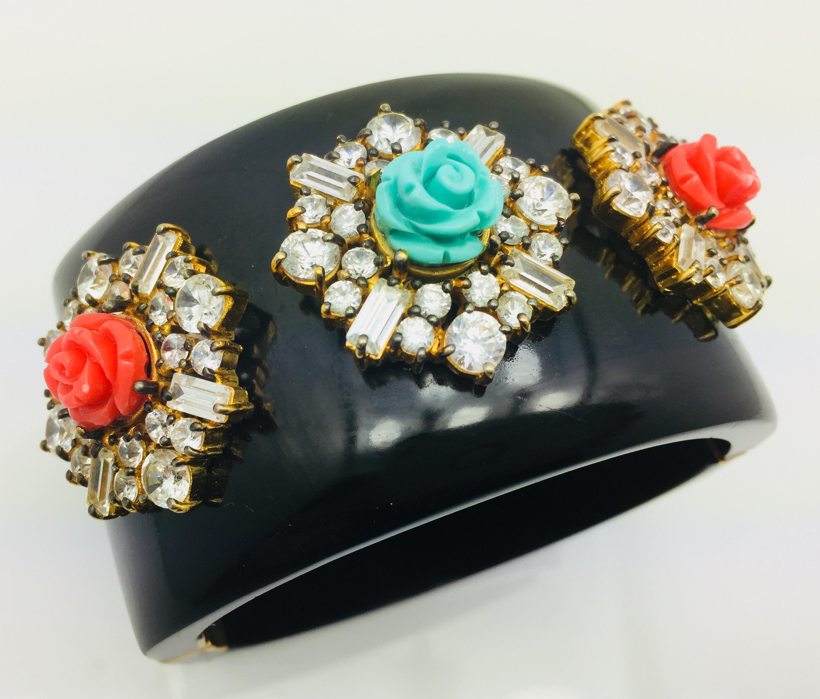 Statement Floral Black Resin Cuff is handcrafted with three hand carved floral rose.  The bold piece is embellished with  baguette crystals and cubic zircons on each motif. The bracelet is hinged and fastens with a push tab insert closure.  Only 1