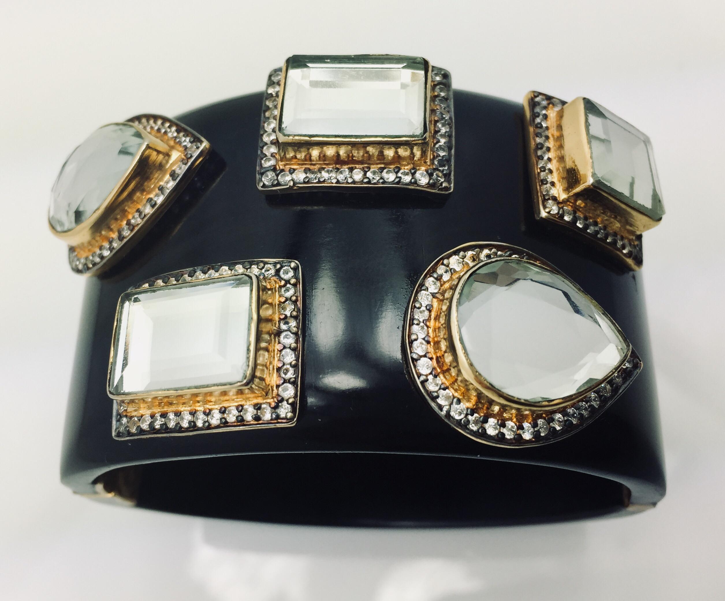 The smooth, black resin bracelet provides a stunning backdrop for the various shapes of light reflective polki mirror stones, each of which has its own frame of dazzling CZs. Bracelet has a hinged, box tab closure.

Available in Black Onyx and