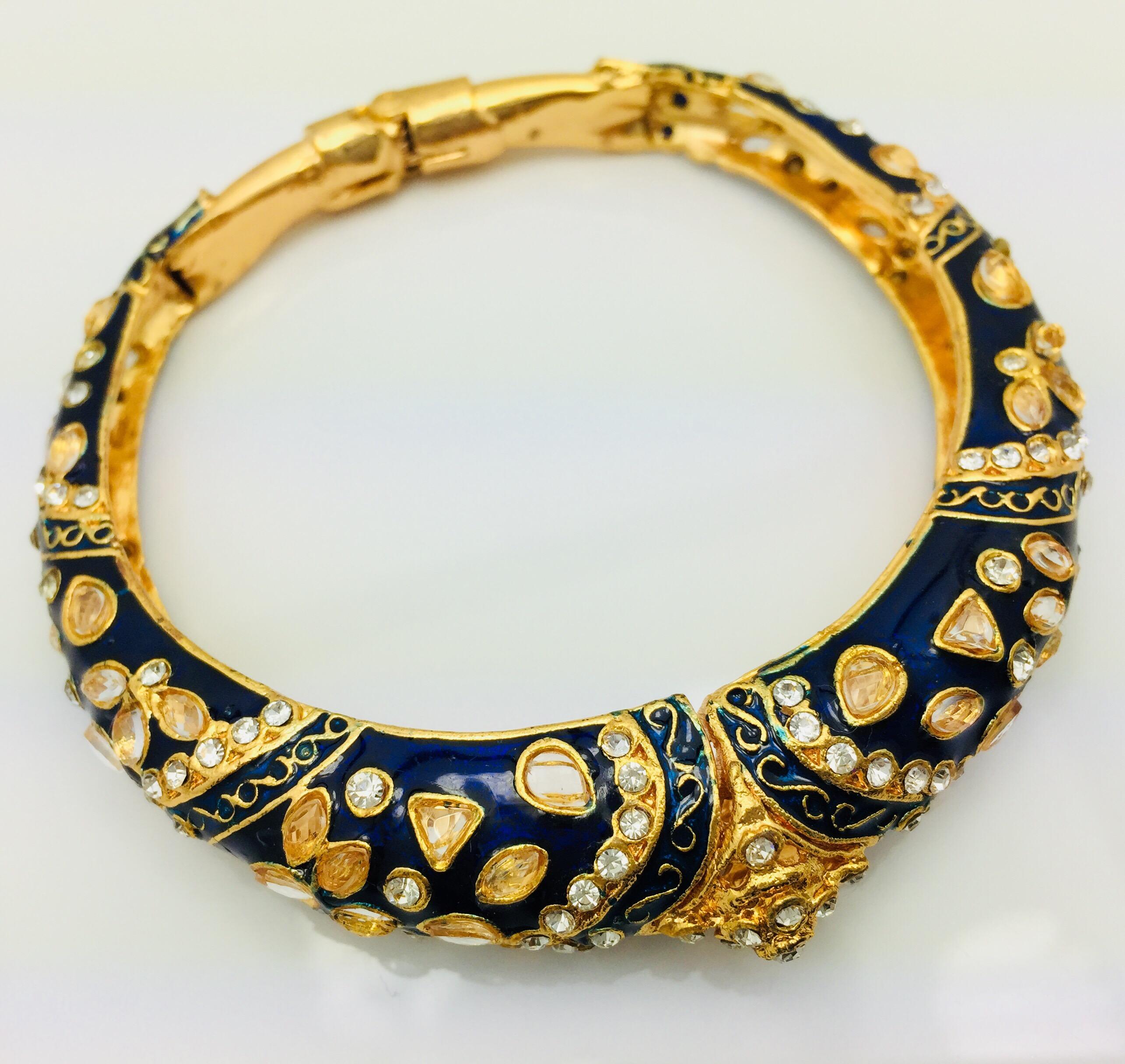Gold tone hinged blue enamel bracelet featuring faux uncut diamond crystals and rhinestones.  
Inner diameter 65.00 mm (2.5 in), inner circumference 204.2 mm (7.00 in)

FOLLOW  MEGHNA JEWELS storefront to view the latest collection & exclusive