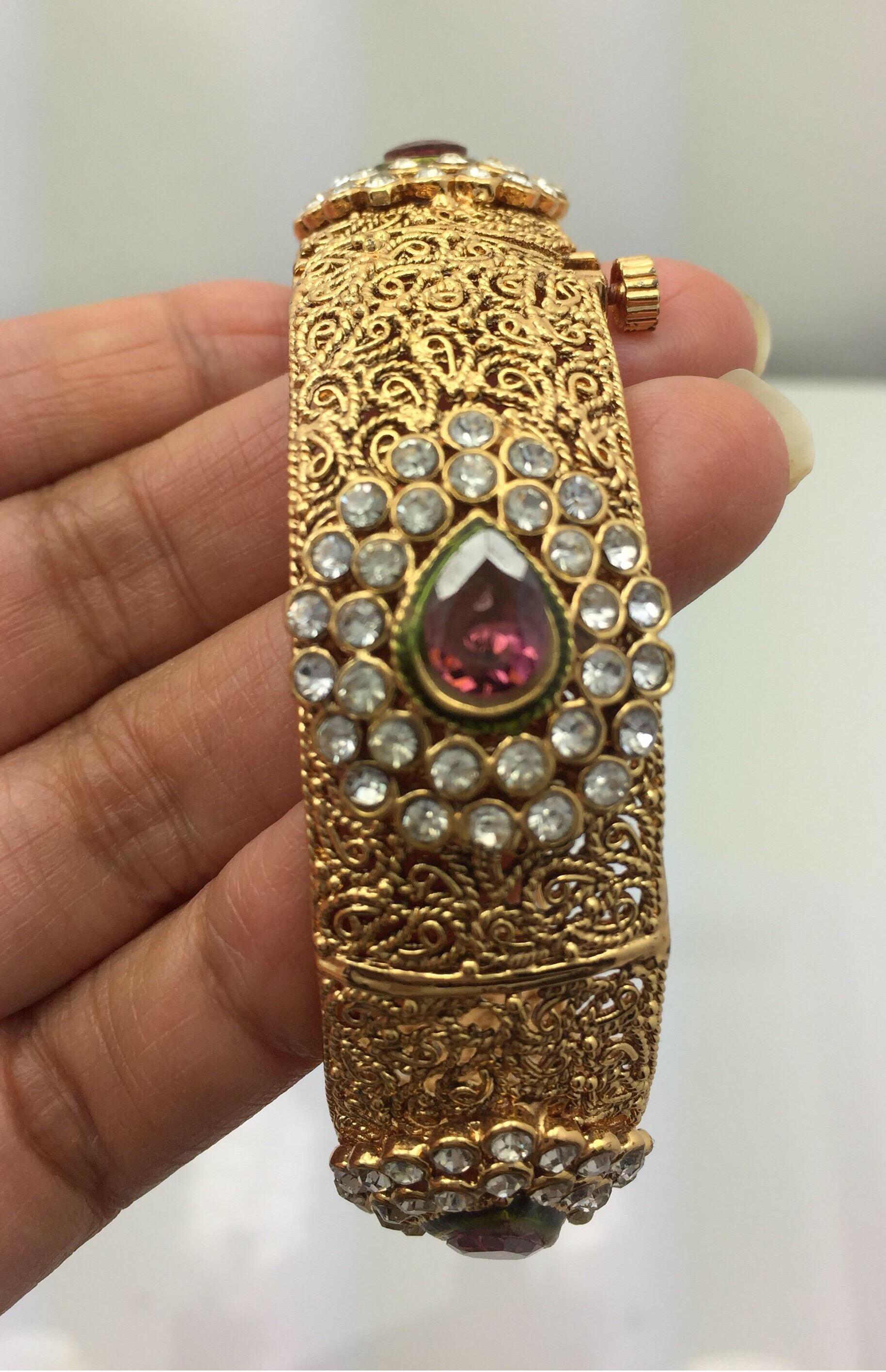 This intricate filigree bangle bracelet is embellished with five faux tourmaline, each surrounded with cubic zircon.  It's is an openable bangle.  
Inner diameter 65.00 mm (2.56 in)

FOLLOW  MEGHNA JEWELS storefront to view the latest collection &