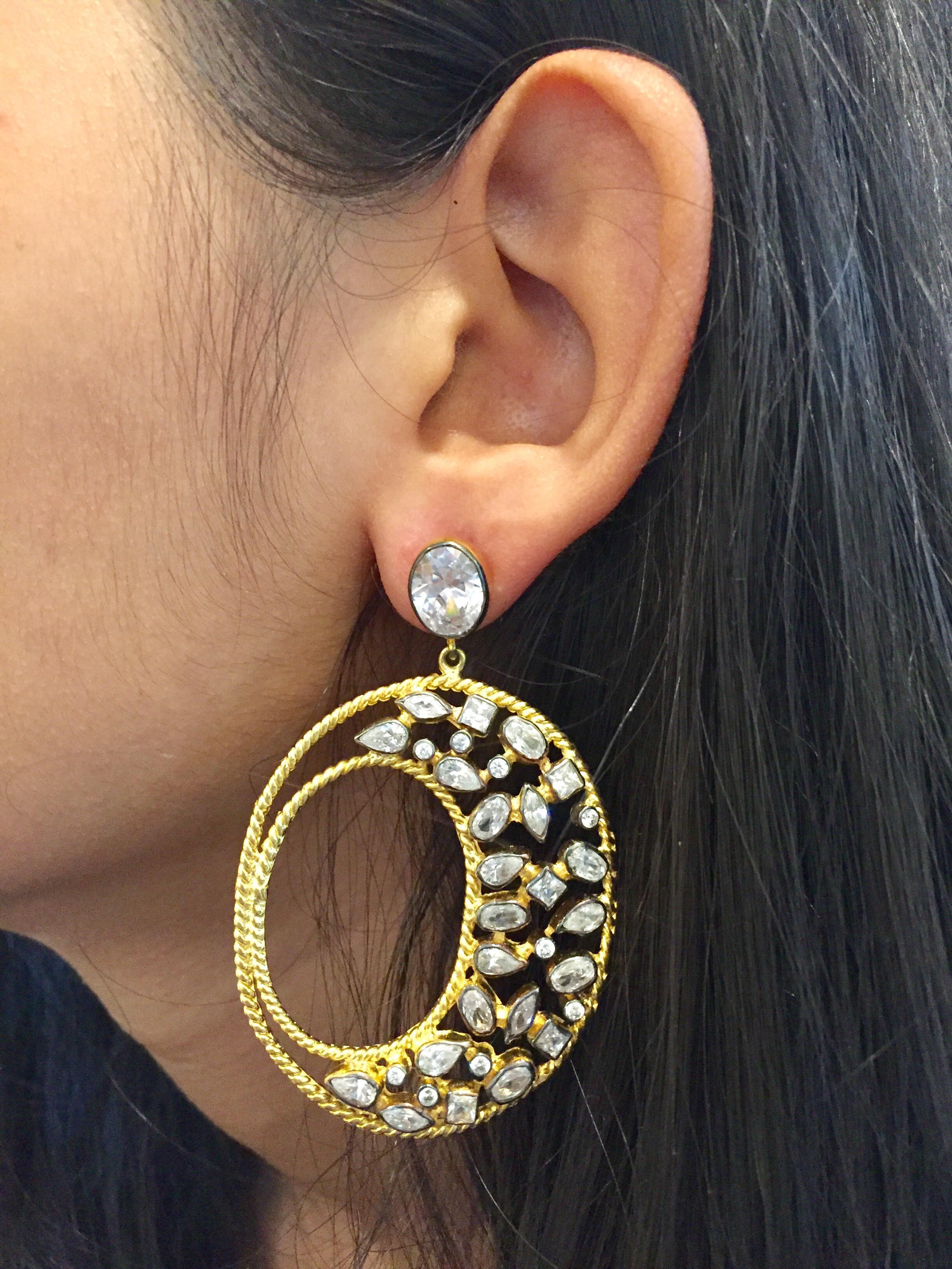 This gorgeous gold and CZ Diva hoop earrings are the ultimate in exotic glamor. With twisted gold wire forming the outline, the field of generously scattered CZ stones delivers unmatched sparkle. These large earrings are versatile enough to