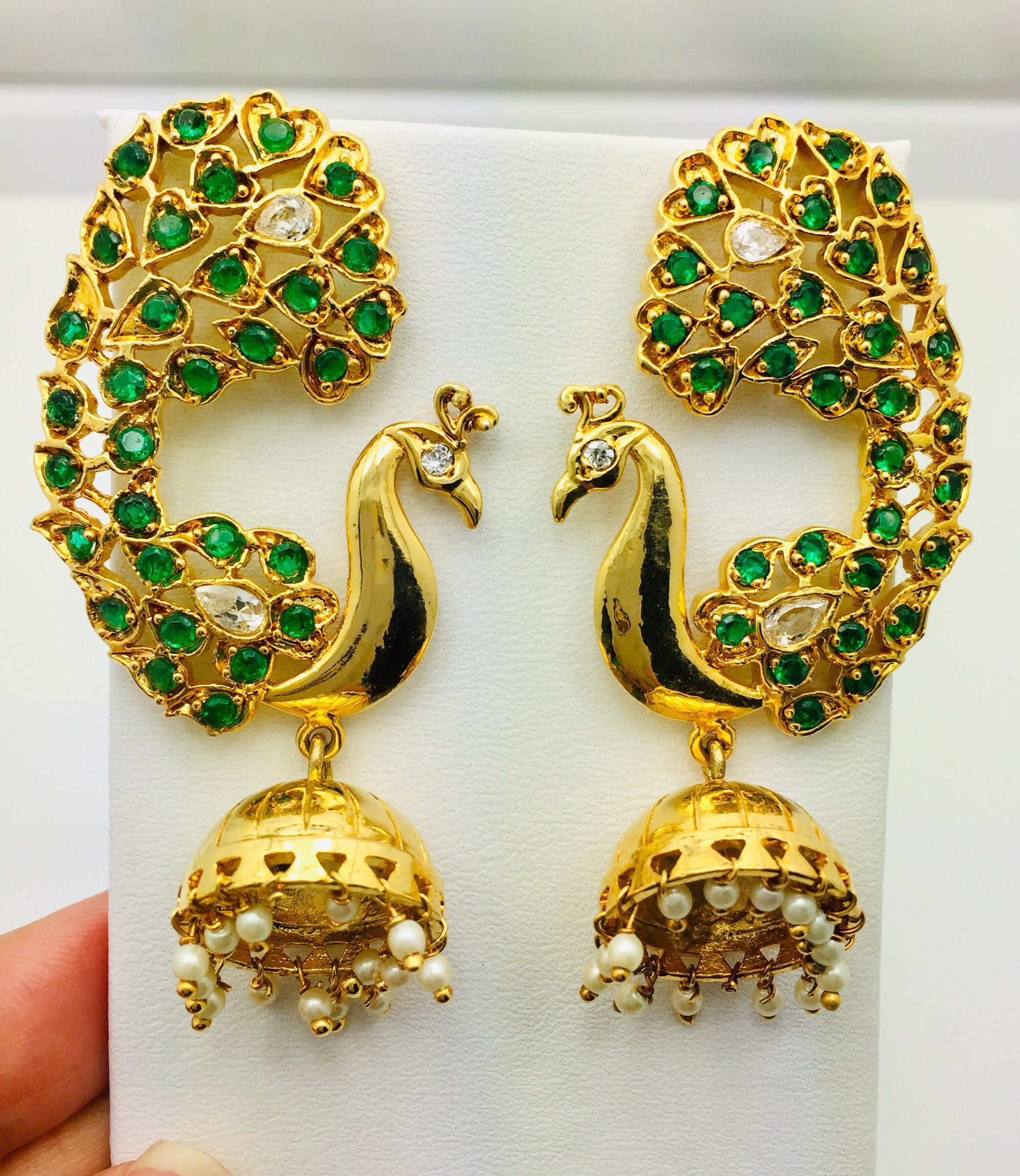 Strut your stuff in these handmade peacock earrings embellished with faux emerald, cubic zircons and pearls. As you can see, the novel creation features a standout design that incorporates some super stylish elements. These earrings fasten with post
