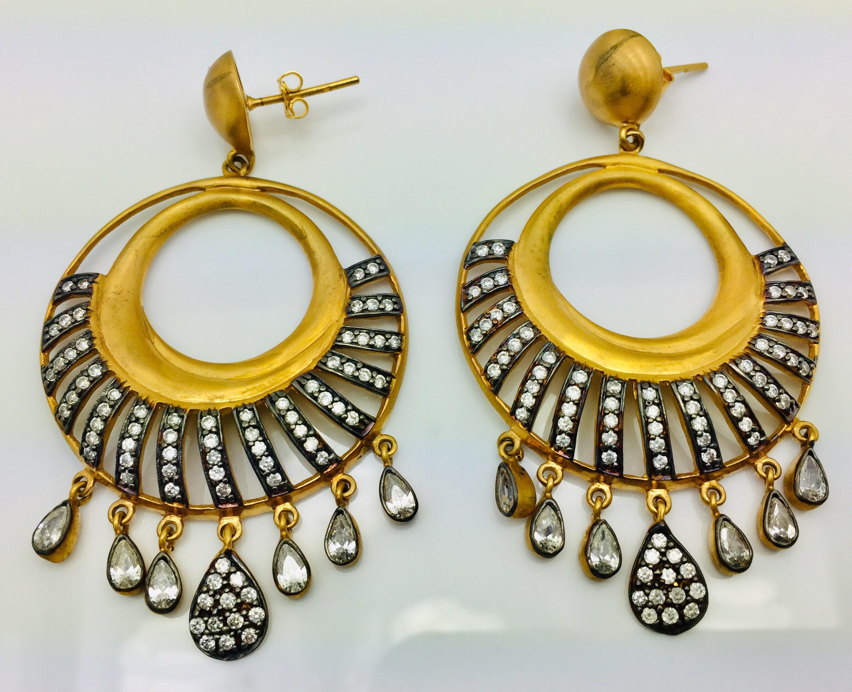 The two tone earrings is hand finished in matte gold tone and oxidized cubic zircon. It is suspended from a circular stud and finished with a multi-faceted crystal drops. 

FOLLOW  MEGHNA JEWELS storefront to view the latest collection & exclusive