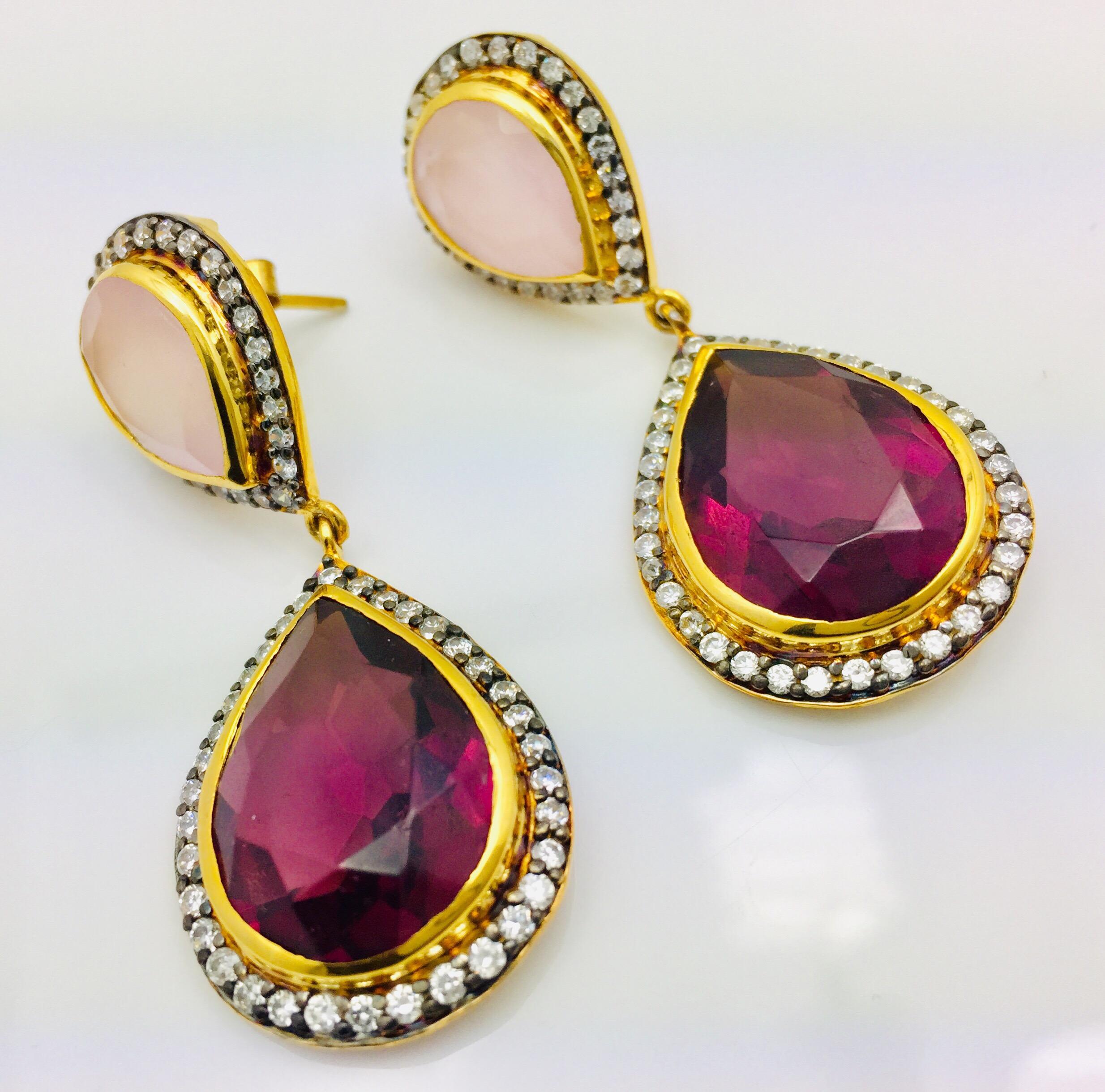 This gold-tone drop earrings is handcrafted with striking faux pear cut rose quartz and deep magenta crystal encased in sparkling cubic zircons.  Measures 2.0