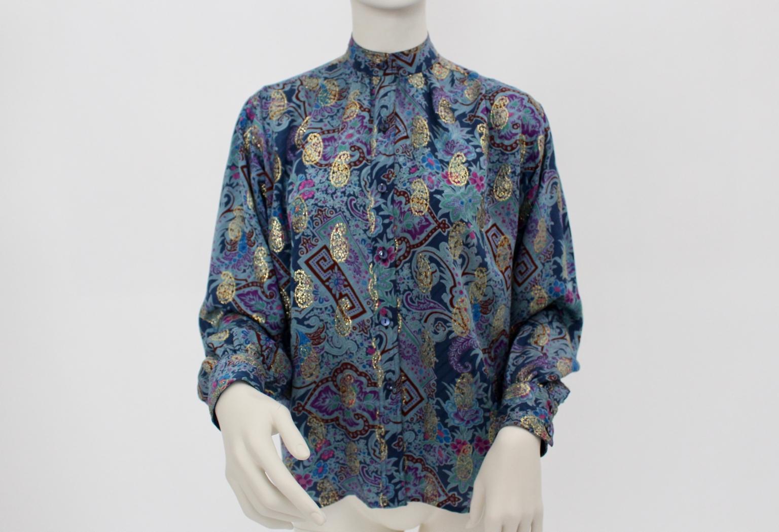 This blouse was designed in the 1980s and made in France. The standing collar blouse impresses through its vibrant colors in blue and paisley pattern.
This exotic pattern was typically for the young 1980s.
Front button closure
Very good vintage