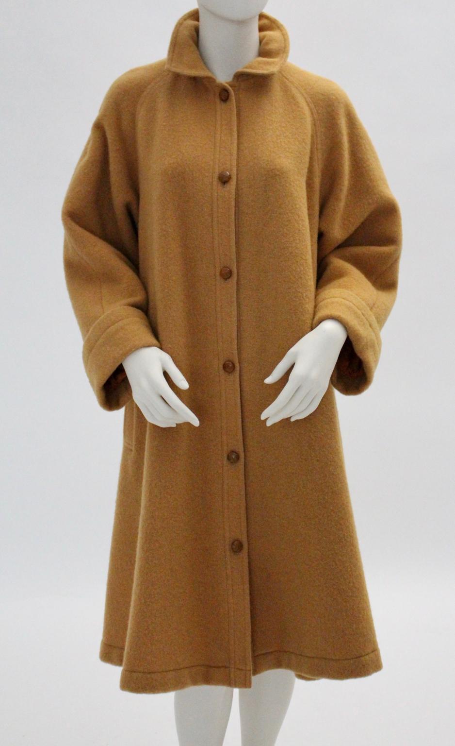 This Coat was designed by Guy Laroche Diffusion Paris 1970s and made in France.
The Coat has raglan sleeves with cuffs, shoulder pads for a great silhouette and six leather covered buttons for closure.
Two pockets on each side.

Labelled
French