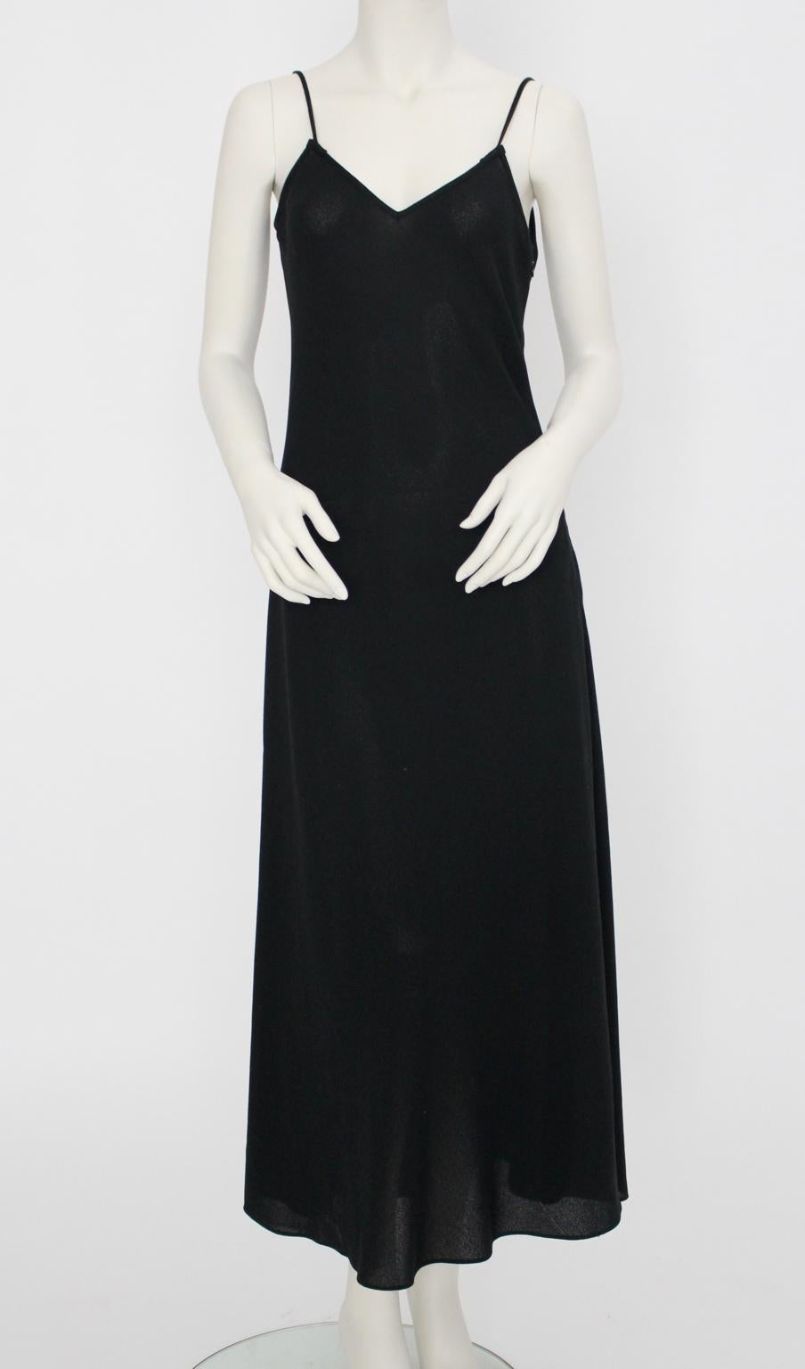 Black Spaghetti Strap Slip Dress made of textil, probably viscose mixed with acryl, with one zip closure on the side.
The dress has no lining, it is a little bit sheer, but you are able to wear it without underwear. 
Great dress to wear it casual or