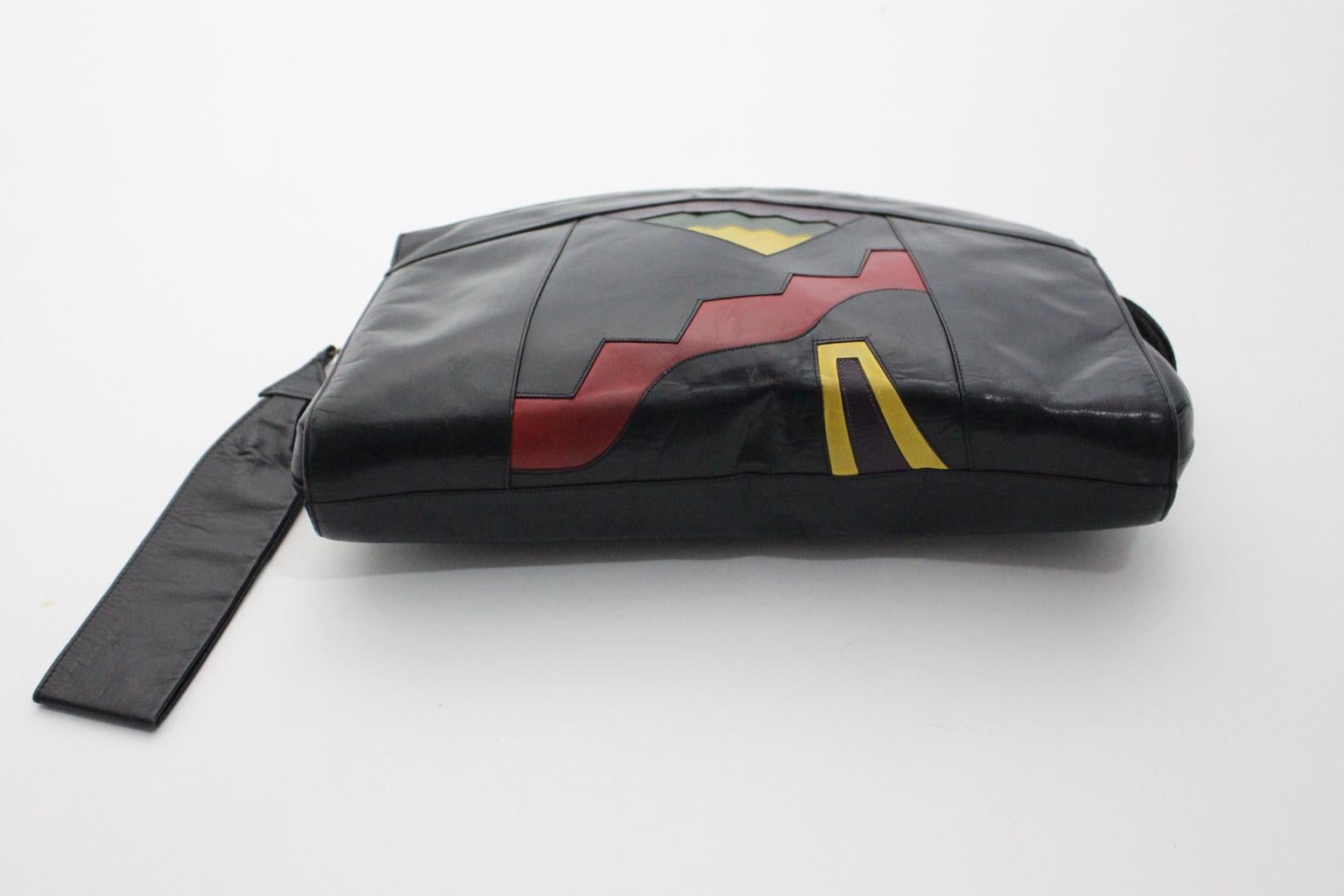 This presented handbag was designed and made by Bruno Magli Bologna. 
A great detail of this handbag is, that the clutch features a removable handle, which is shaped like a flash.
The handbag was made of black leather and shows a decorating in