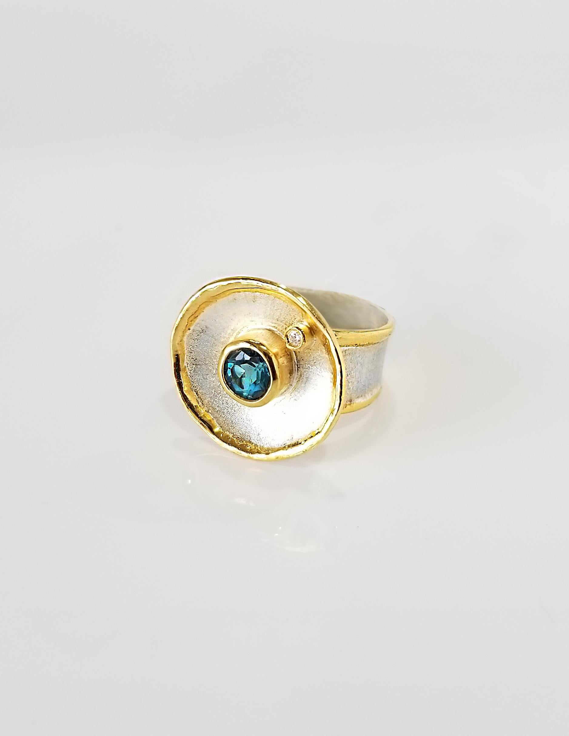 Yianni Creations 100% Handmade Ring from Fine Silver with a layover of 24 Karat Yellow Gold features 1.55 Carat London Blue Topaz accompanied by 0.03 Carat Diamond complimented by unique techniques of craftsmanship - brushed texture and