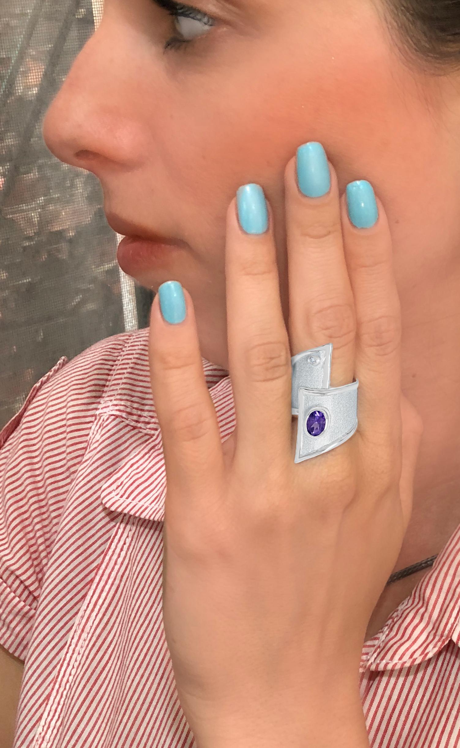 This handmade fine silver Ring features a 1.25 Carat Amethyst. It also features a small brilliant cut real diamond of 0.03 carats. 
Our workshop takes great pride in their craftsmanship and especially how they work with the metal. A technique that