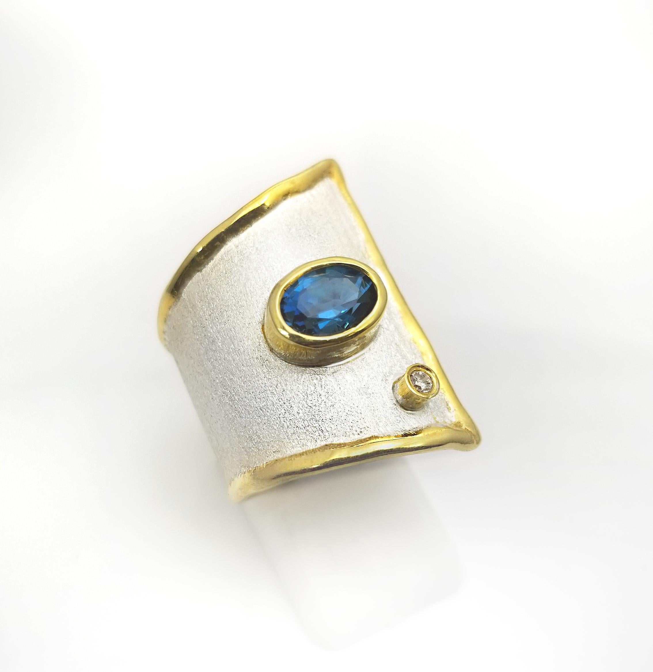 This handmade fine silver Statement Ring features a 1.60 Carat London Blue Topaz. It also has a brilliant cut diamond weighing 0.03cts.

Inspired by the geometric era, this design is the Largest one of its family. The straight lines that this ring