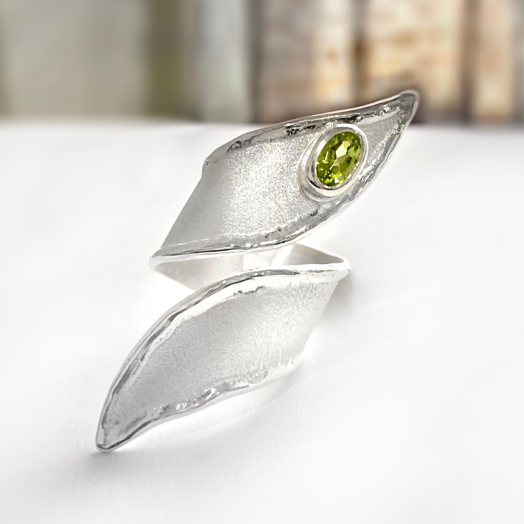 Yianni Creations 100% Handmade Ring from Fine Silver featuring 0.50 Carat Peridot complemented by unique techniques of craftsmanship - brushed texture and nature-inspired liquid edges in asymmetric design that literally hugs your finger, making an