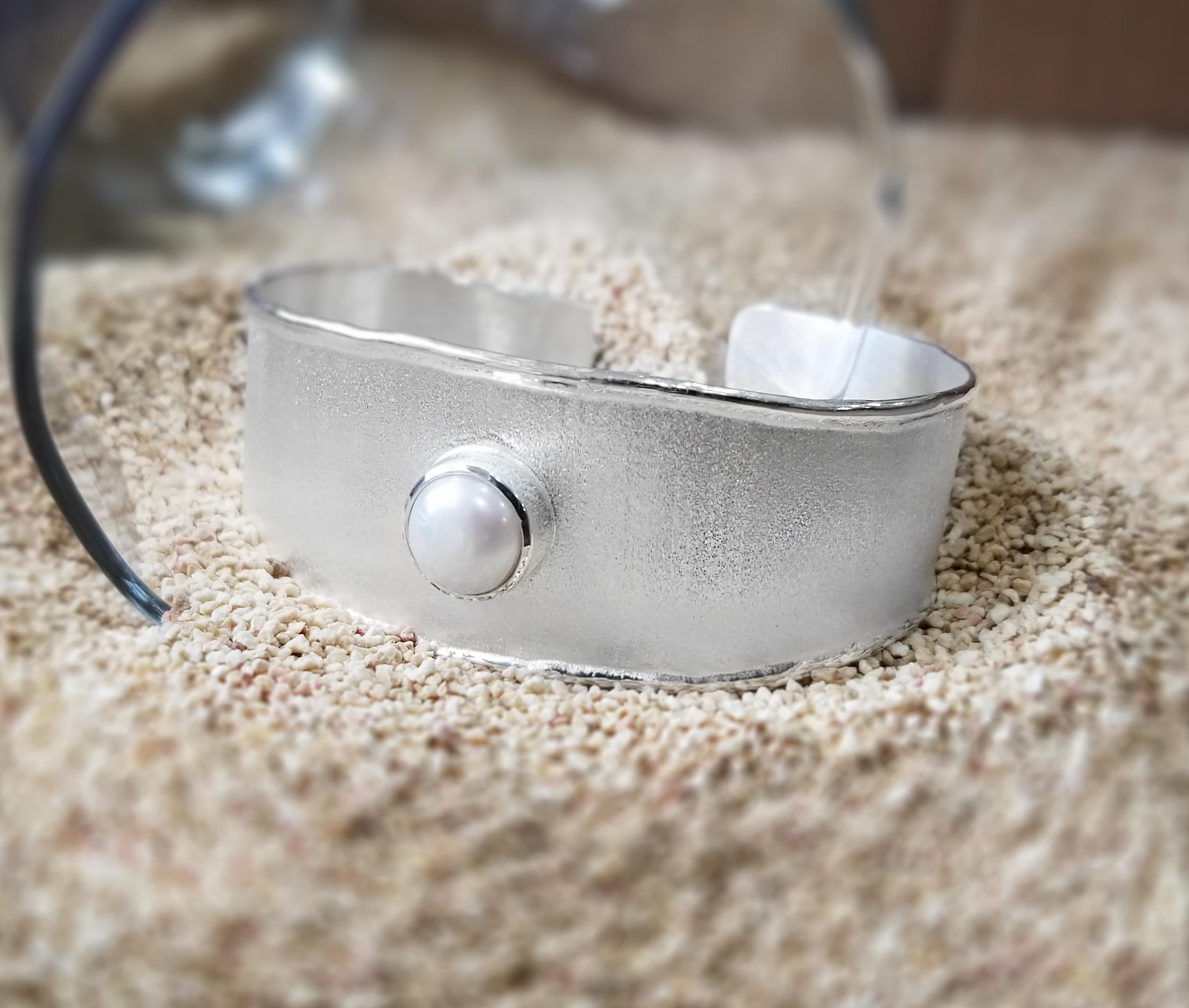 Yianni Creations 100% Handmade Bracelet from Fine Silver featuring 9 -9.5 mm Freshwater Pearl complemented by unique techniques of craftsmanship - brushed texture and nature-inspired liquid edges. The core of this beautiful simplified bracelet is