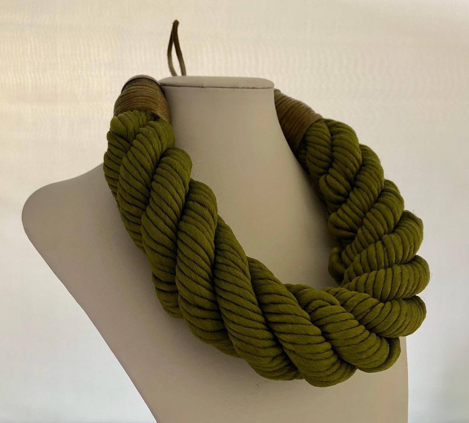 Chic and fashion current sculptural statement bib necklace by Premier Etage, Paris. The monumental necklace is comprised of woven green silk cord. The necklace is hand twisted and manipulated in all Parisian technique to create a bold and unique