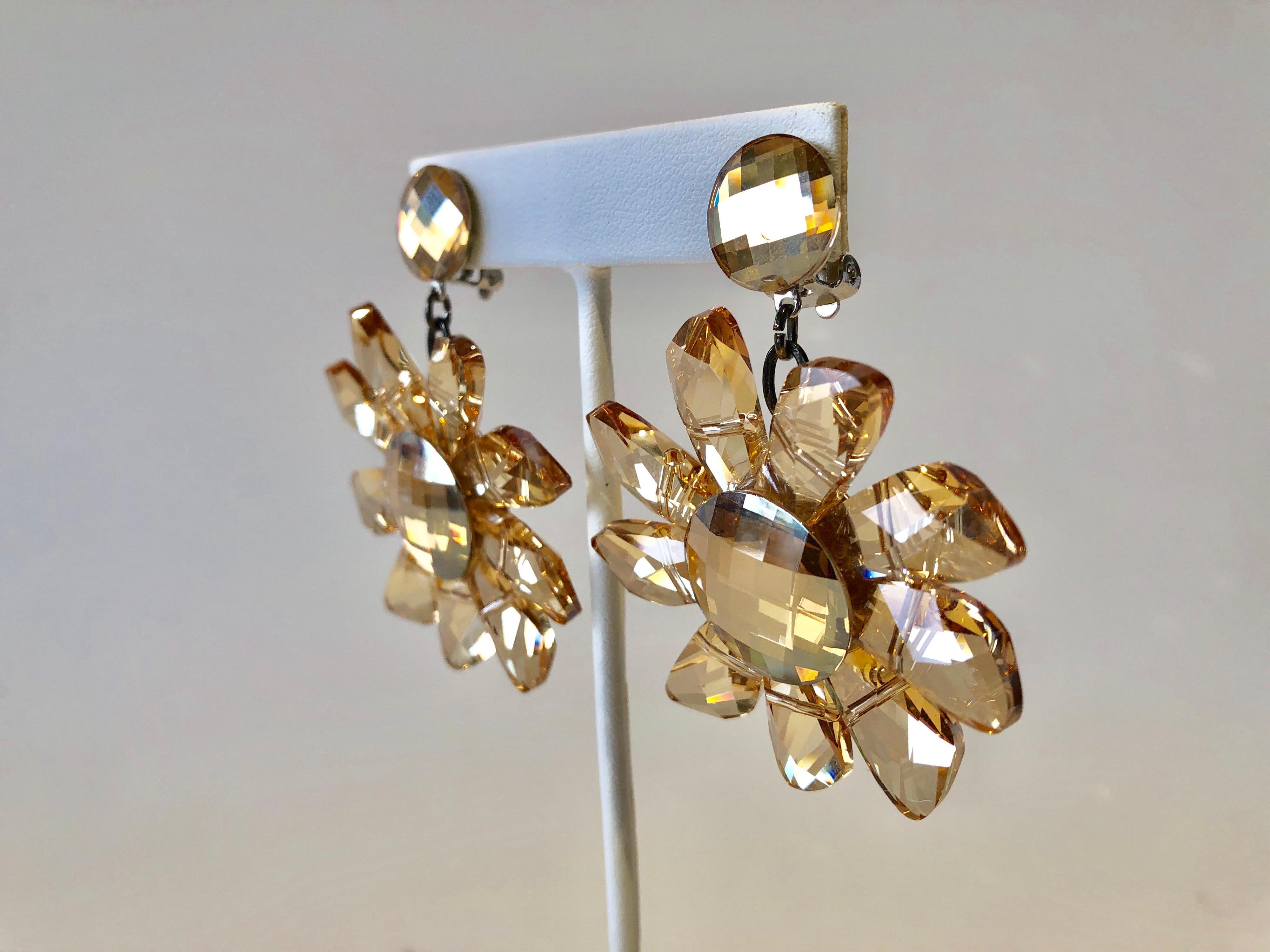 Vintage designer champagne colored architectural flower faceted crystal statement clip-on earrings made in Paris Frace - constructed out of faceted geometric crystals depicting contemporary flowers. The earrings are a lovely shade of