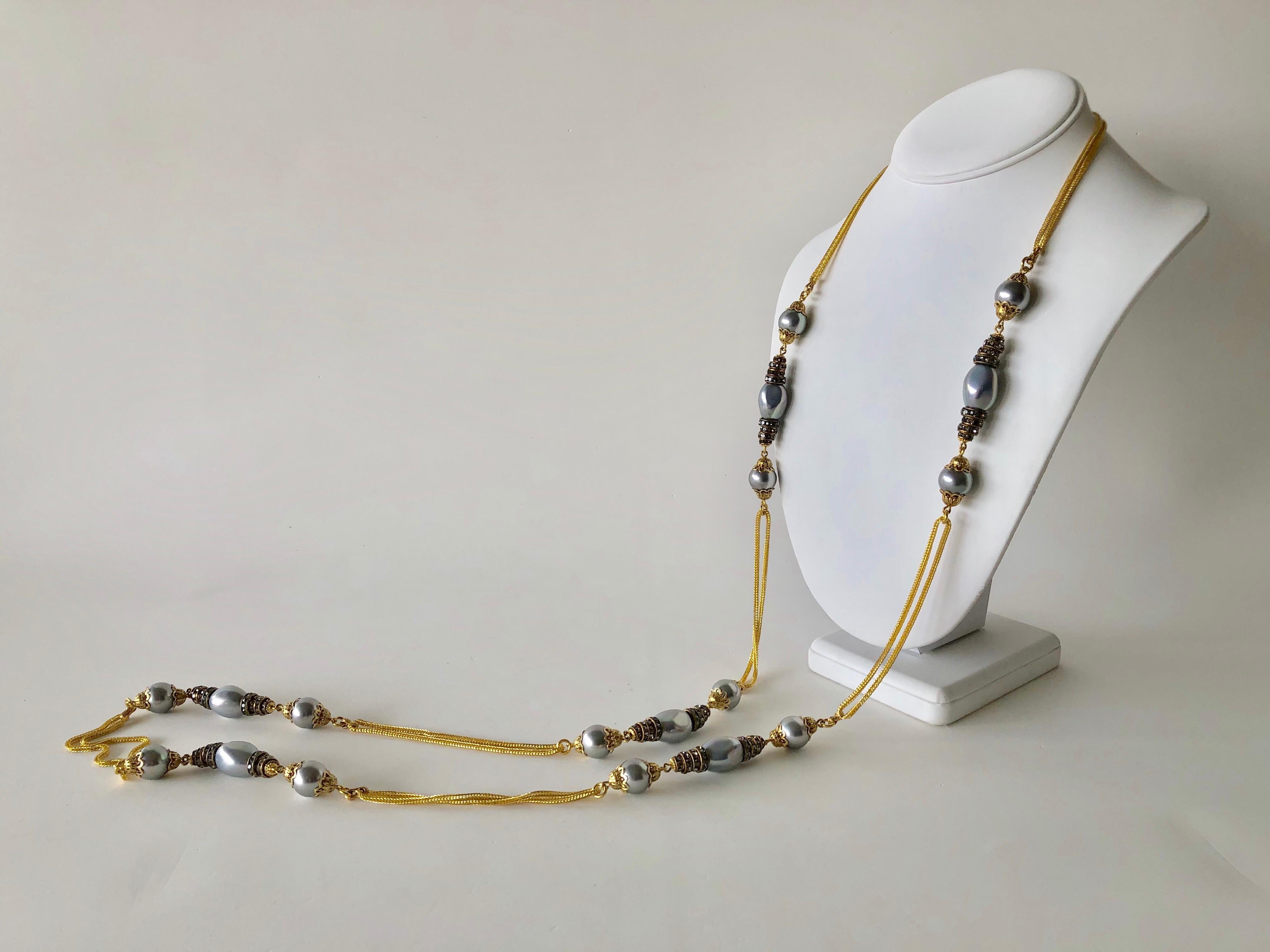 Contemporary baroque pearl and diamante gilt long statement necklace -  comprised of gilt metal chain the necklace exudes Parisian sophistication due to its simplistic design and mixture of large grey baroque faux pearls and rondels. Its length