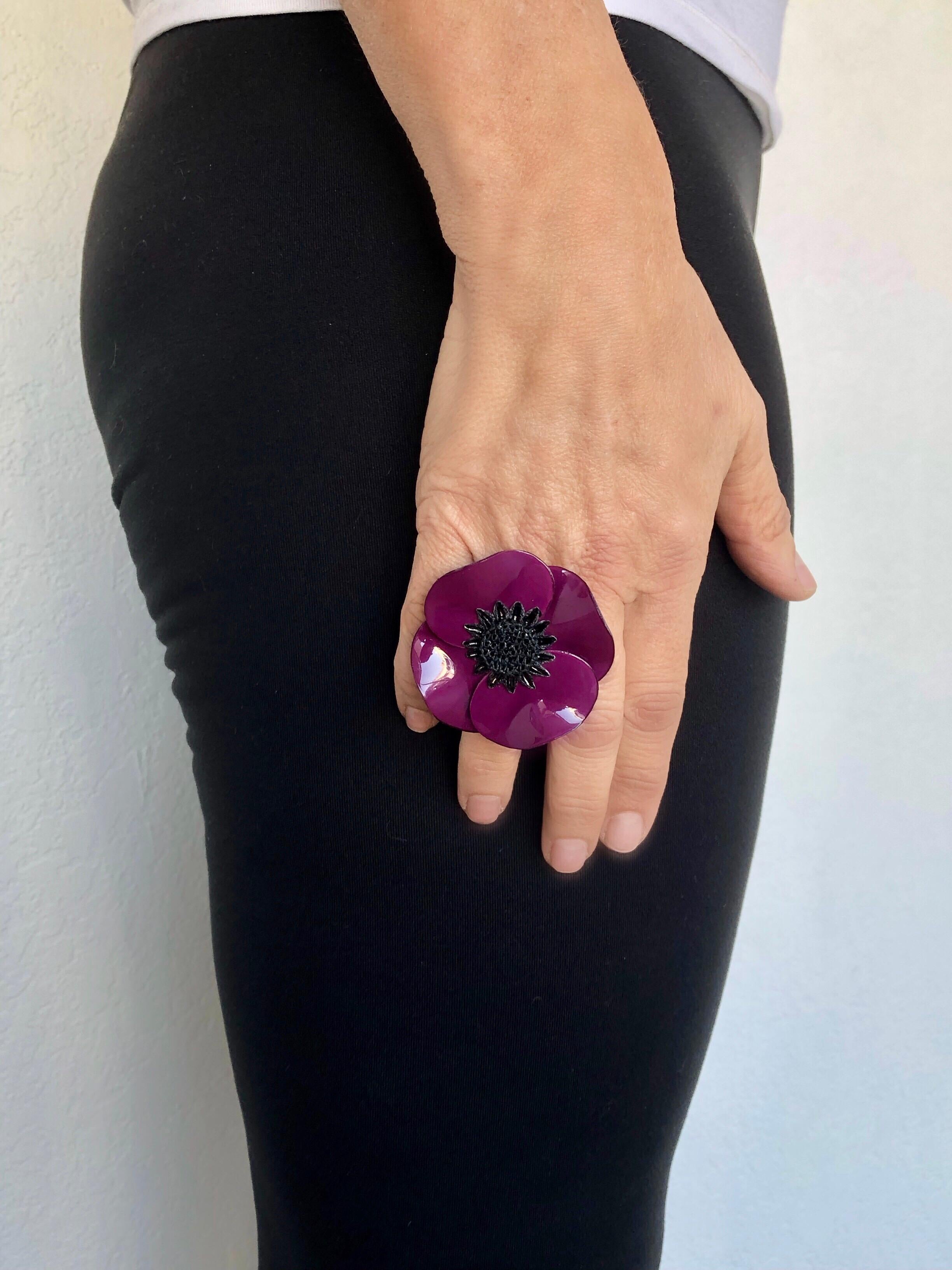 Light and easy to wear, this adjustable artisanal ring was made in Paris by Cilea. The lightweight adjustable ring feature a single architectural enameline (enamel and resin composite) purple poppy flower. The poppy is oversized and features a black
