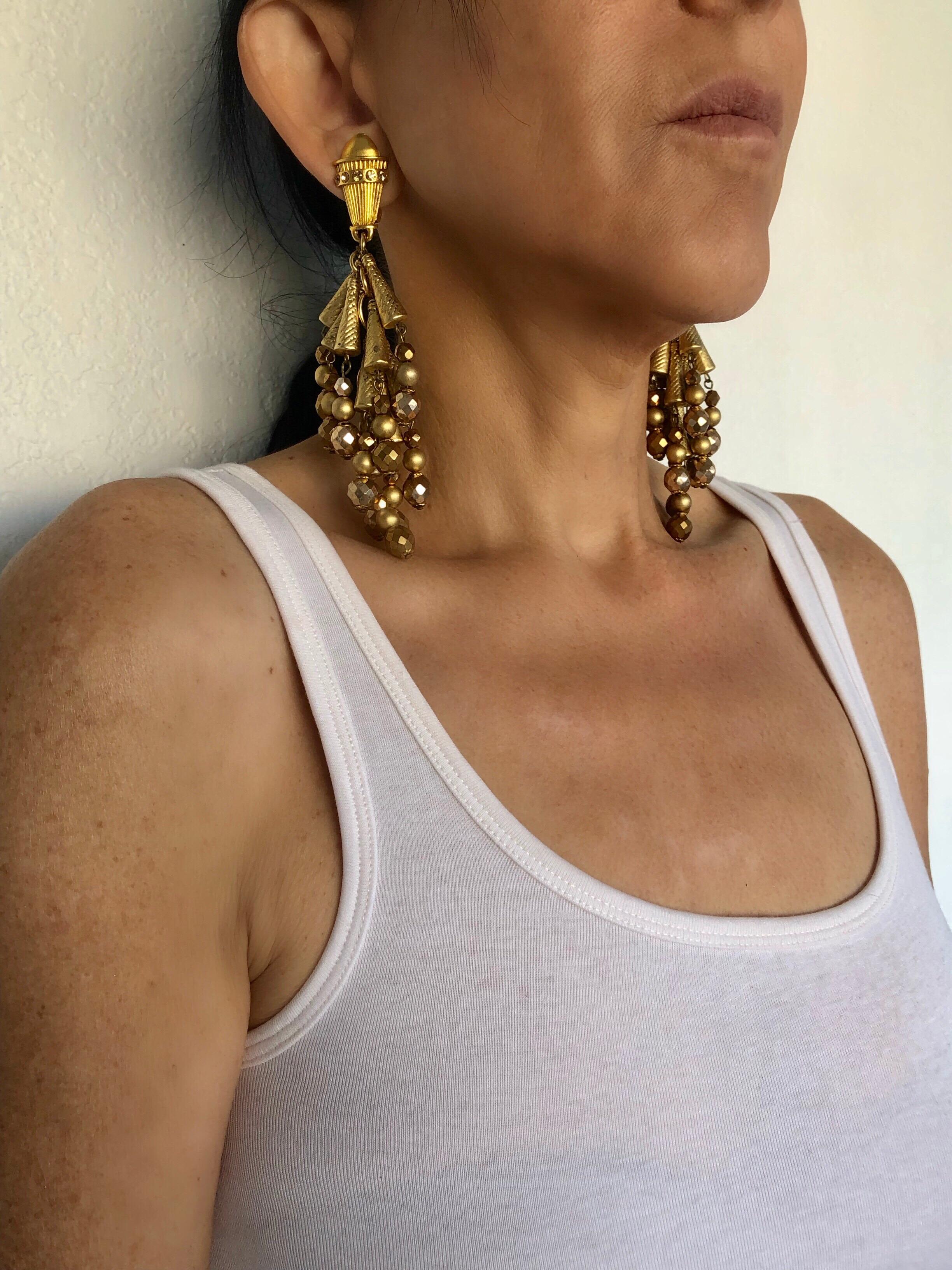 Vintage made in France architectural dangle statement shoulder duster earrings designed by Claire Deve paris for Claude Montana. The spectacular pair of clip-on earrings are comprised on a plethora of mat-gold  architectual metal beads of different