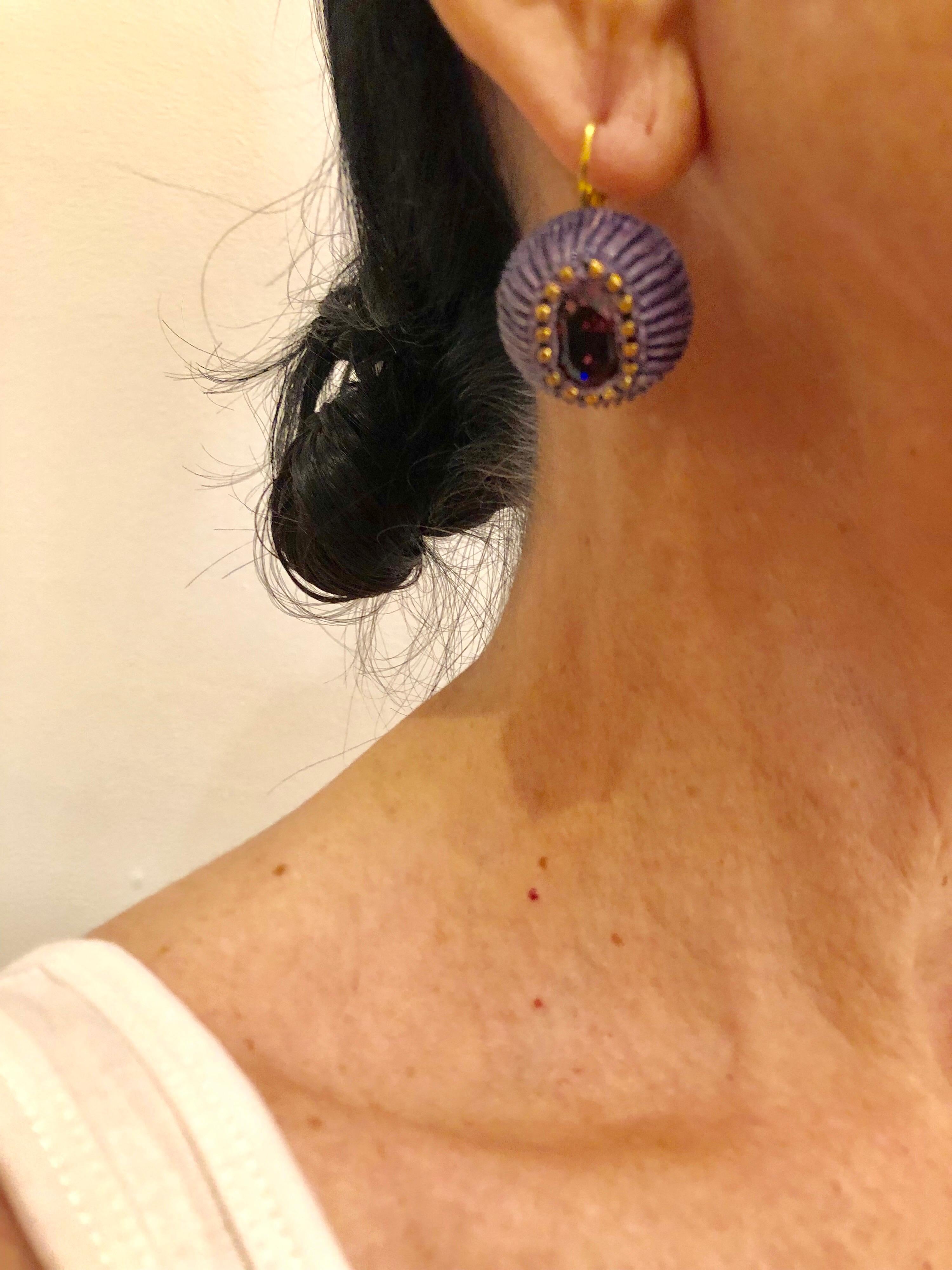 Light and easy to wear, these handmade artisanal comtemporary earrings were made in Paris by Cilea. The lightweight pierced dangle statement earrings are comprised out of purple and gold resin/enamel and feature a large glass purple rhinestone at