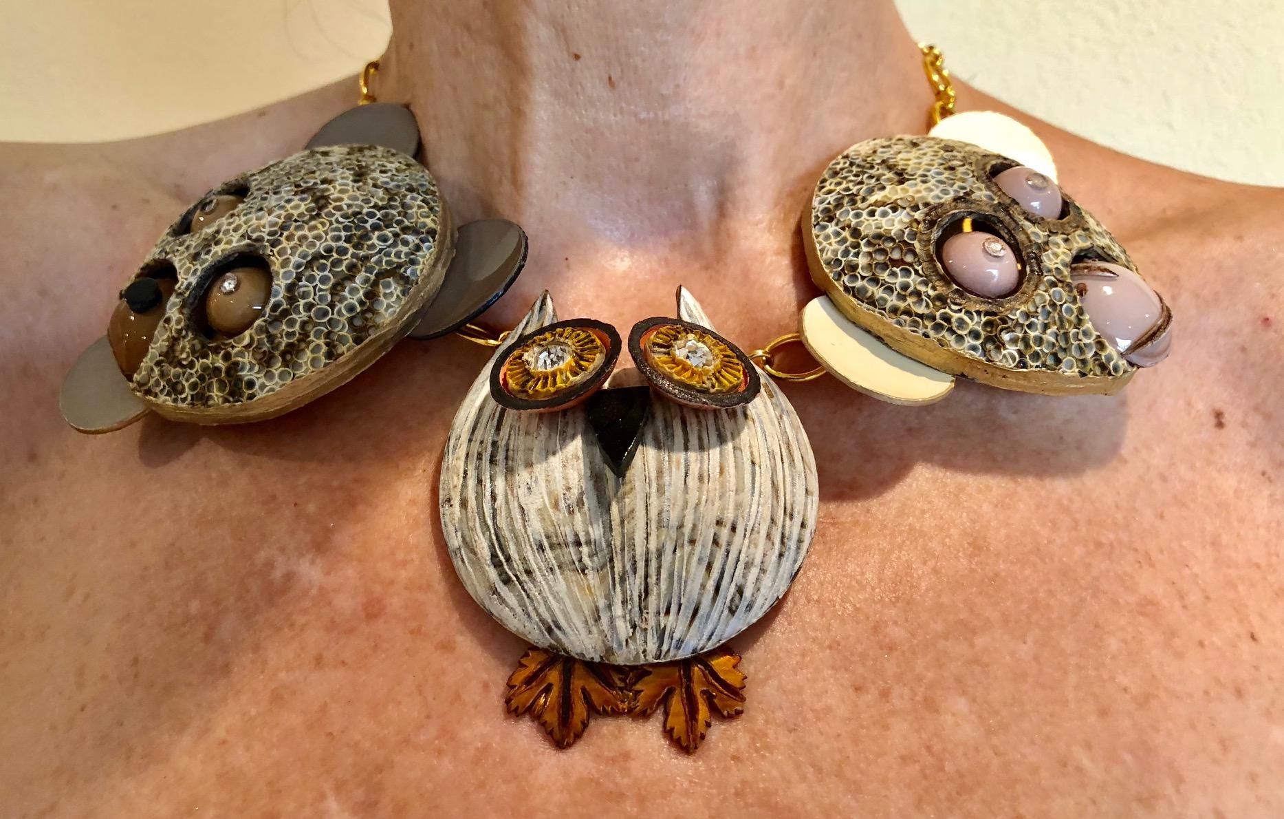Light and easy to wear, this handmade artisanal necklace was made in Paris by Cilea.  The necklace features three large enameline (enamel and resin composite) animal figures, a bear, owl, and monkey all three with rhinestones eyes. A limited in