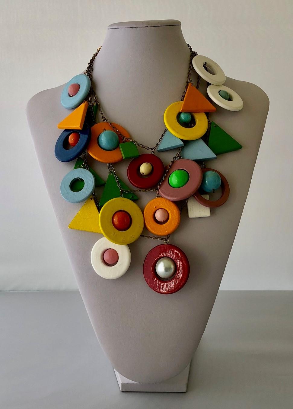 This bold psychedelic statement necklace is comprised out of three rows of metal chain which adorned by multicolor lacquered wood geometric shapes. Light in weight and easy to wear. Also it was featured in Elle Magazine, Italia, February of 2007.