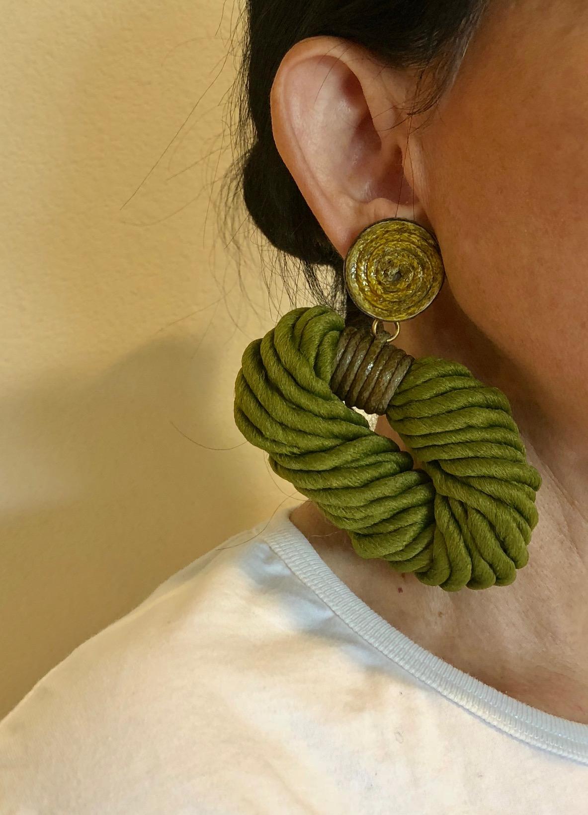 Chic and fashion current contemporary sculptural statement vintage clip-on earrings by Premier Etage, Paris. The monumental earrings are comprised of woven silk cords are accented by an aged swirl circular clip. In all of my years in collecting and