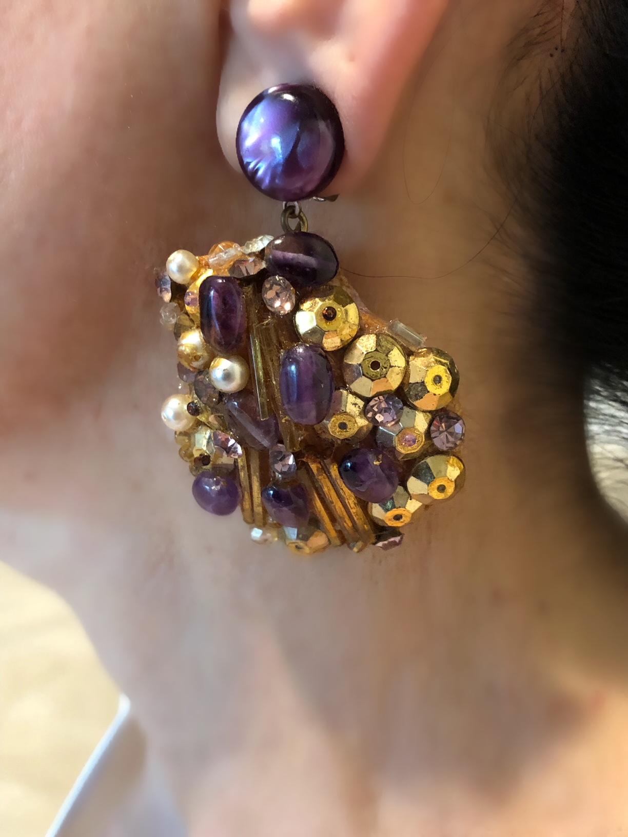 Exquisite handcrafted Italian dimensional statement clip-on earrings. The earrings are comprised of natural sea shells which are covered and adorned with white pearls, gold sequins, long glass bugle beads and accented by purple glass beads. These