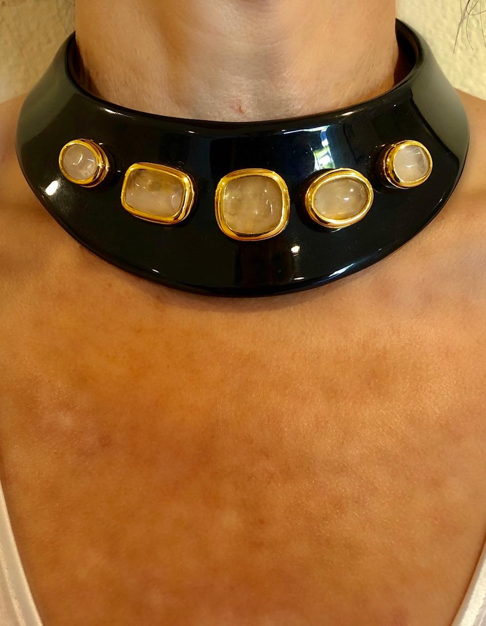 Chic, modern and sleek vintage statement necklace comprised out of black galalith (resin) by French House Goossens. The bold necklace is accented by five large polished geometric rock crystal cabochons mounted on a gold-tone base.  The necklace was