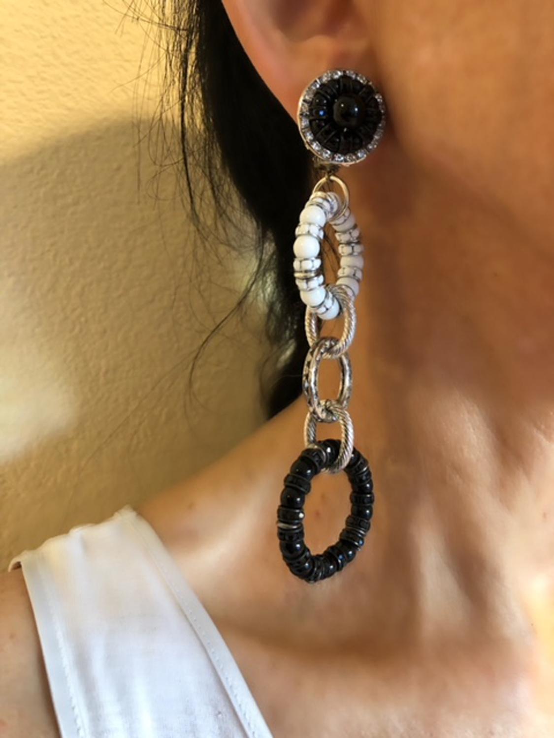 A dramatic and stylish pair of architectural clip-on earrings, comprised of three beaded (glass beads) circles in black, white and clear rhinestones. The earrings were handcrafted in Paris by the house of Francoise Montague.

Note: Our model said