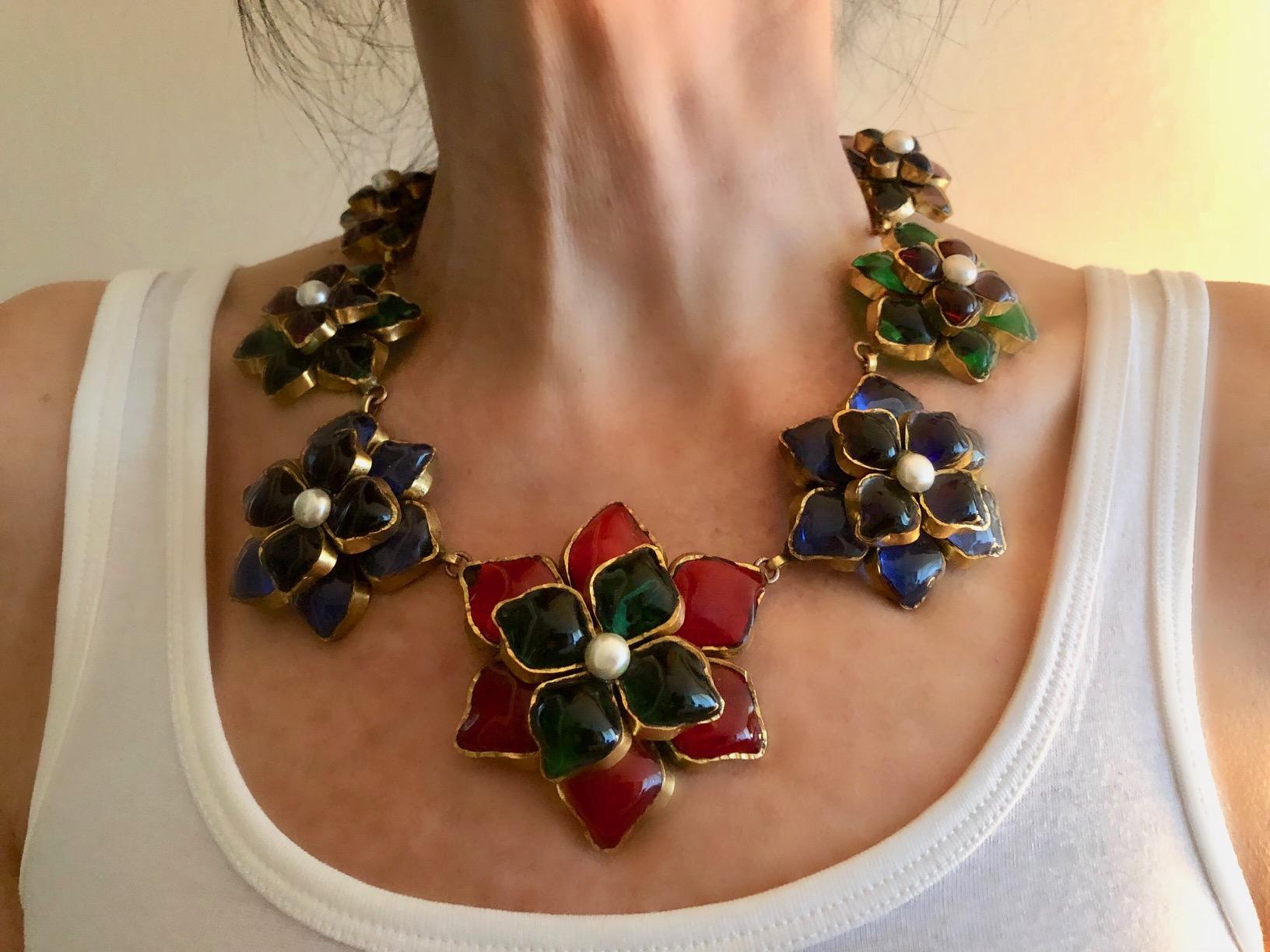 This important and scarce Chanel statement necklace is comprised of handcrafted gilt metal and pate de verre (poured glass) by Maison Gripoix in Paris circa early 1980's. Incredibly unusual in all Chanel manner it features six large colored flowers