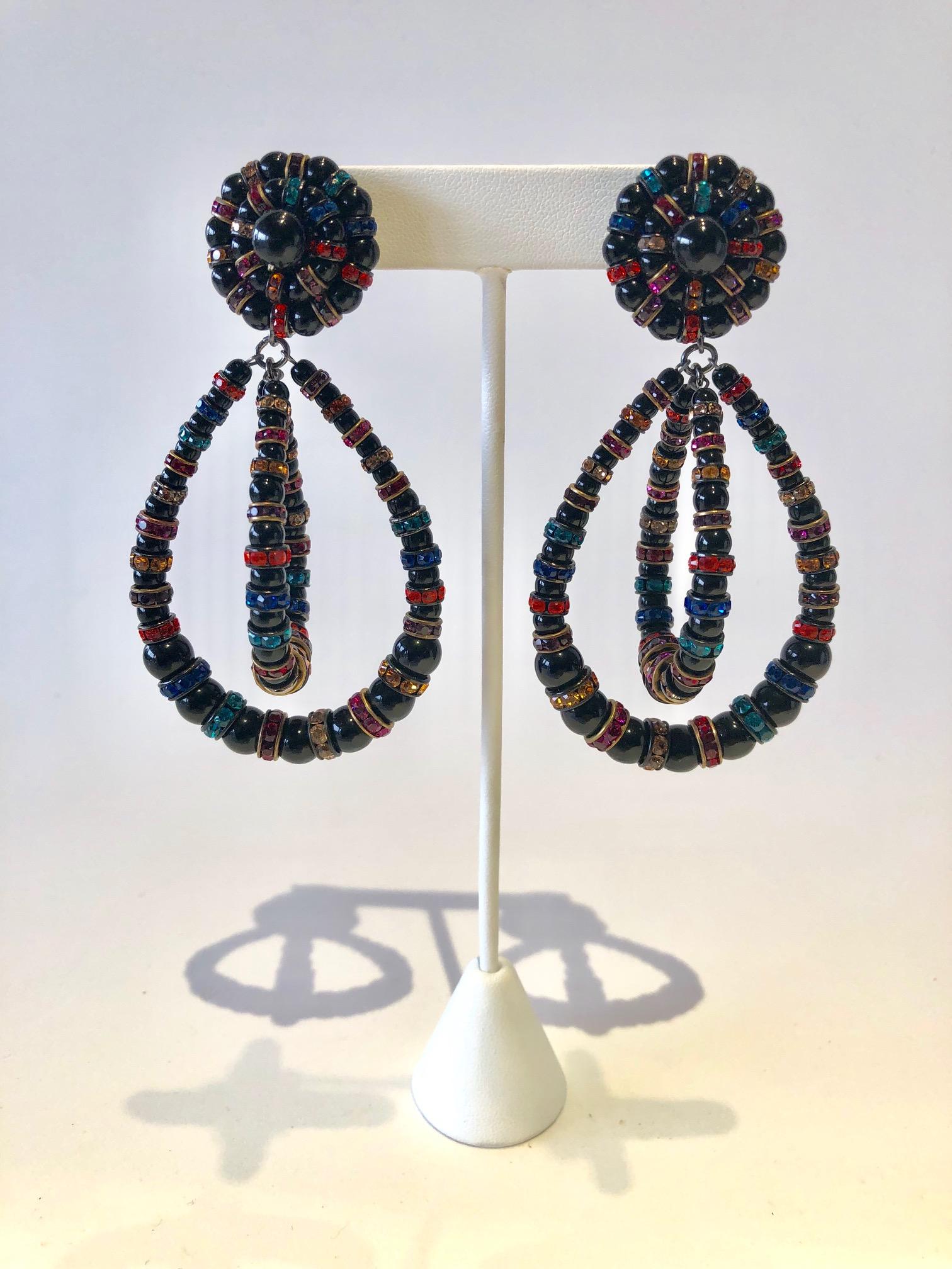 French designer architectural statement clip-on earrings made in Paris by Francoise Montague - the earrings feature jet black glass beads which are accented by a plethora of multi-colored rondels in hues of blue, red, orange and green. What's