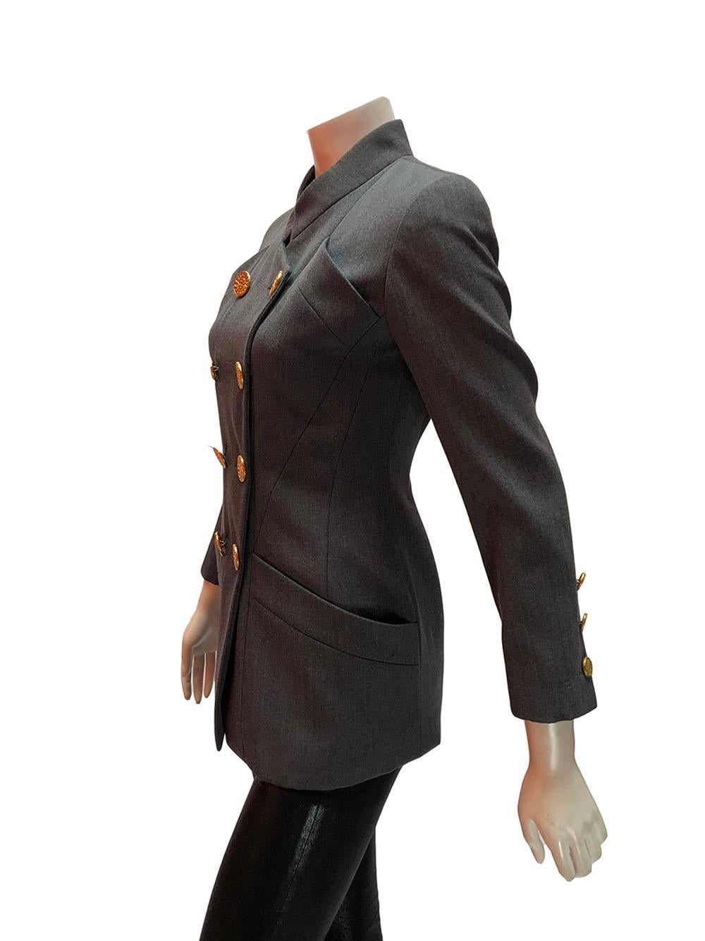 Grey structured military-style double breasted blazer by Chanel. The gold buttons have a chain detail. Two large hip pockets. Size 36. 
